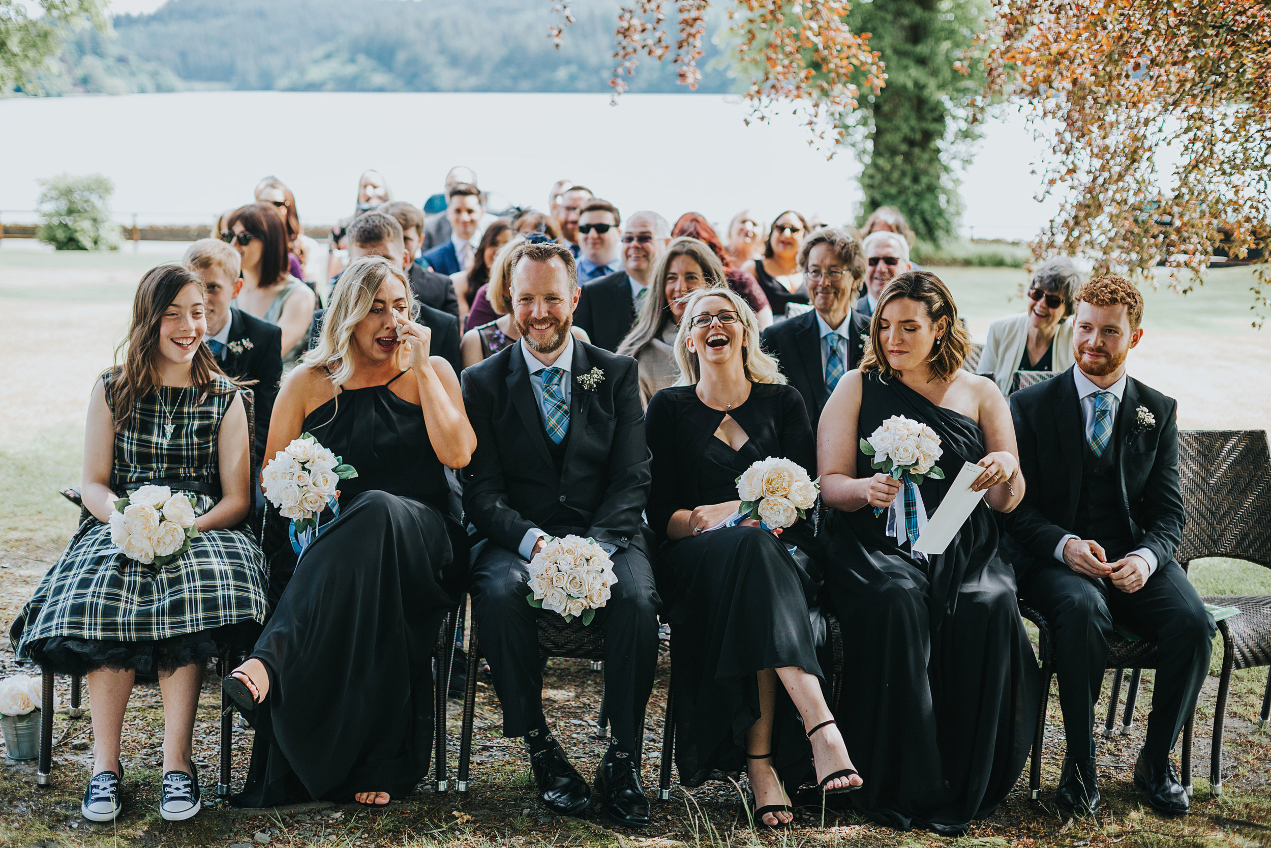 wedding guests fall about laughing. 