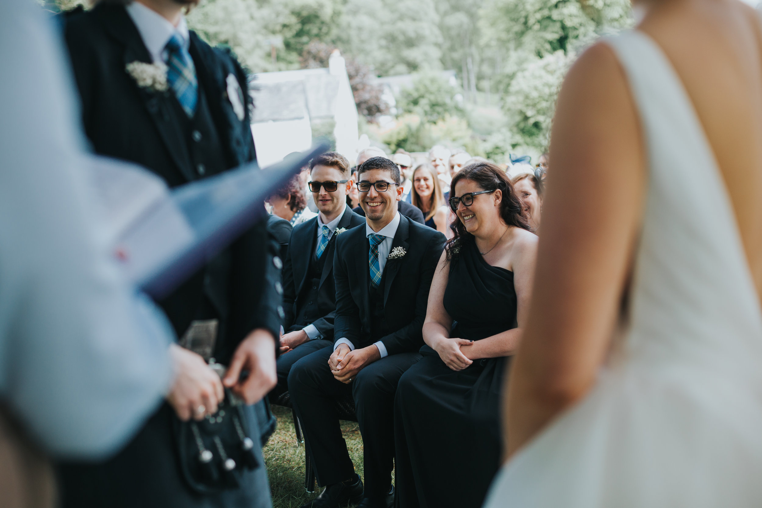 Groomsmen laugh at reading. 