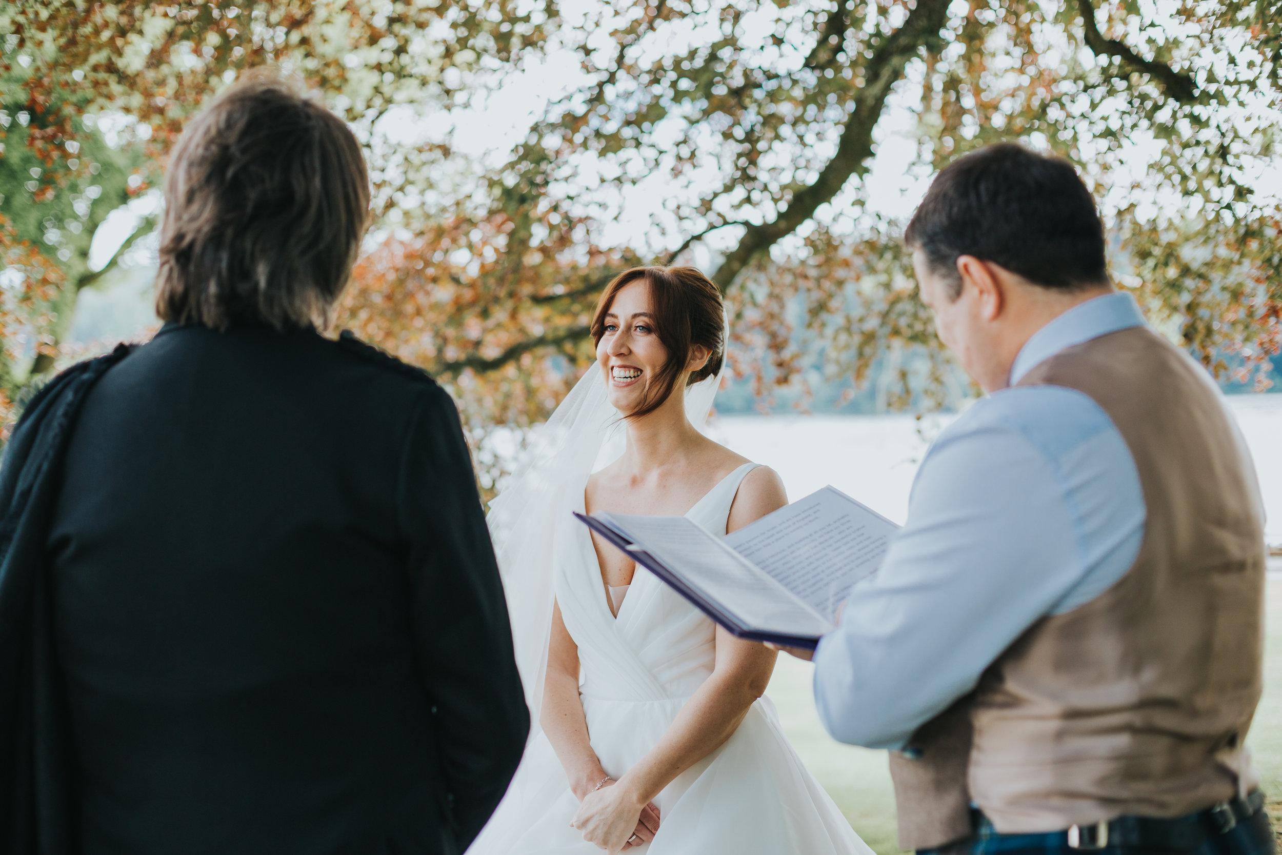 Bride laughs at reading. 