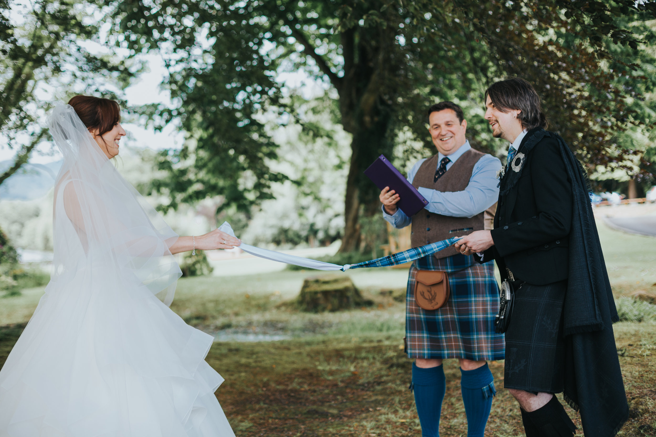 Bride and Groom tie the knot in hand fasting ceremony. 