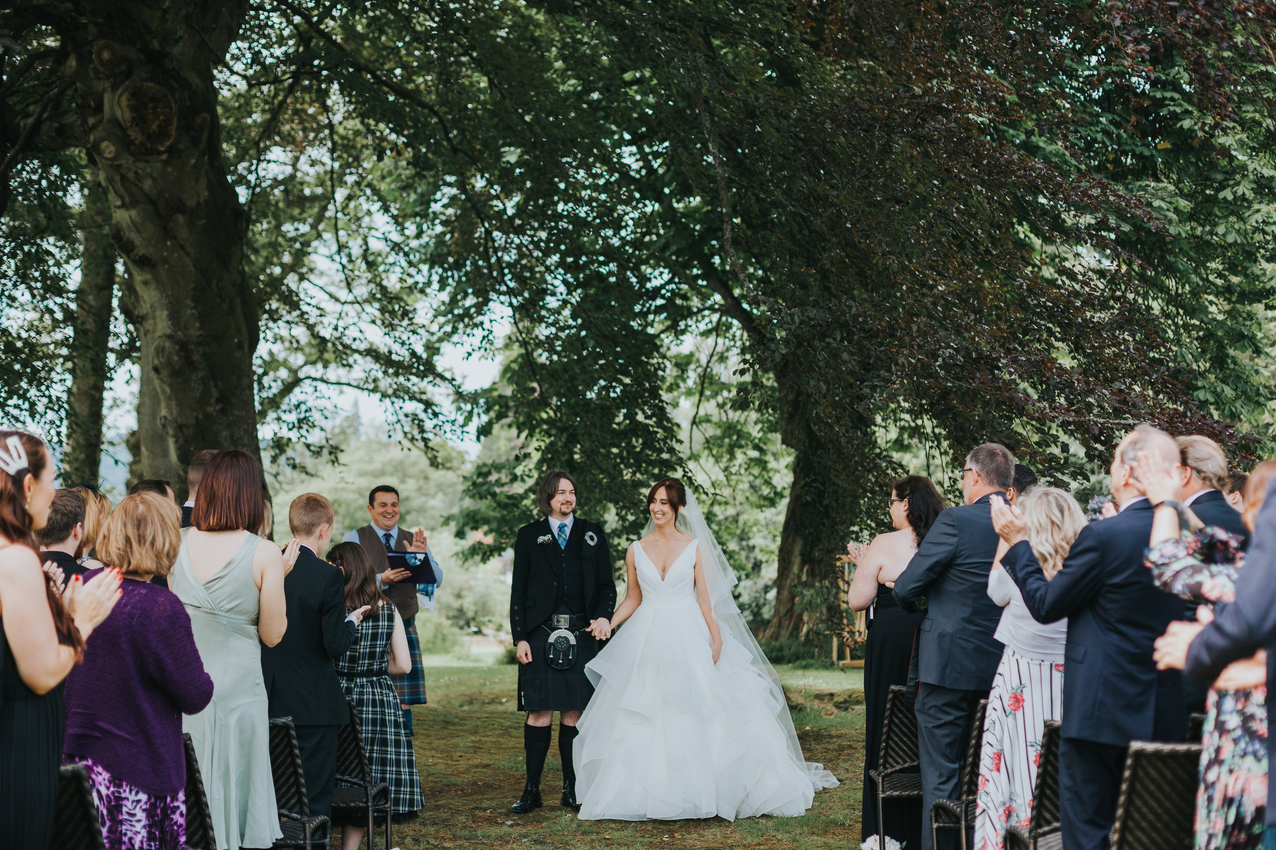 Bride and groom walk down the aisle together. 