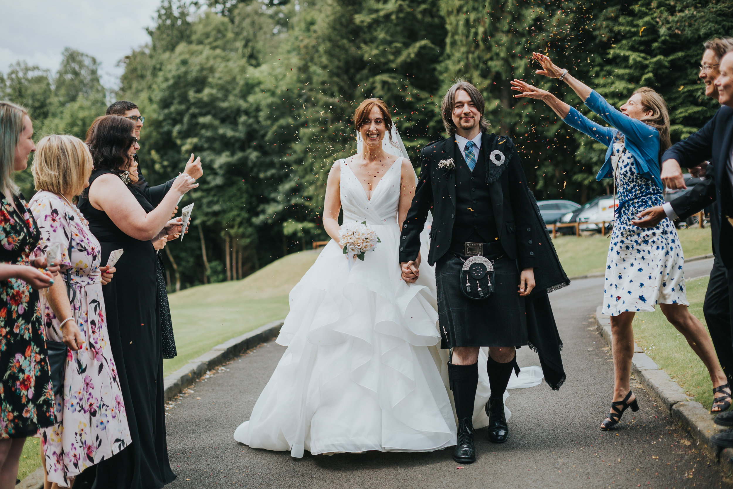 Bride and groom start confetti walk.