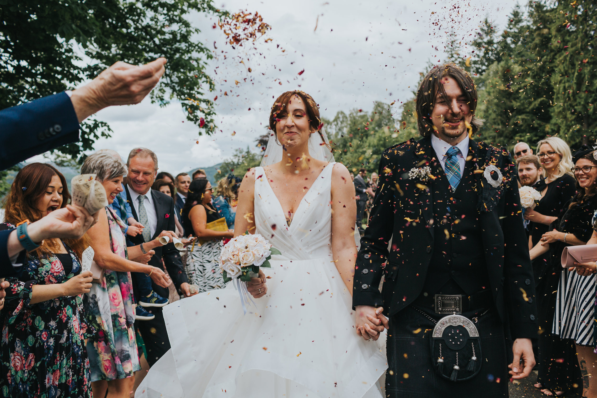 Couple get confetti in their face. 
