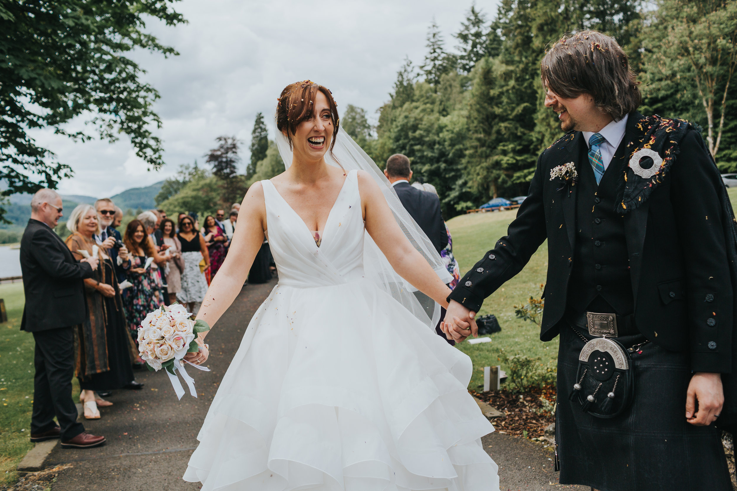 Couple survive confetti throwing near Loch Ard, Scotland.
