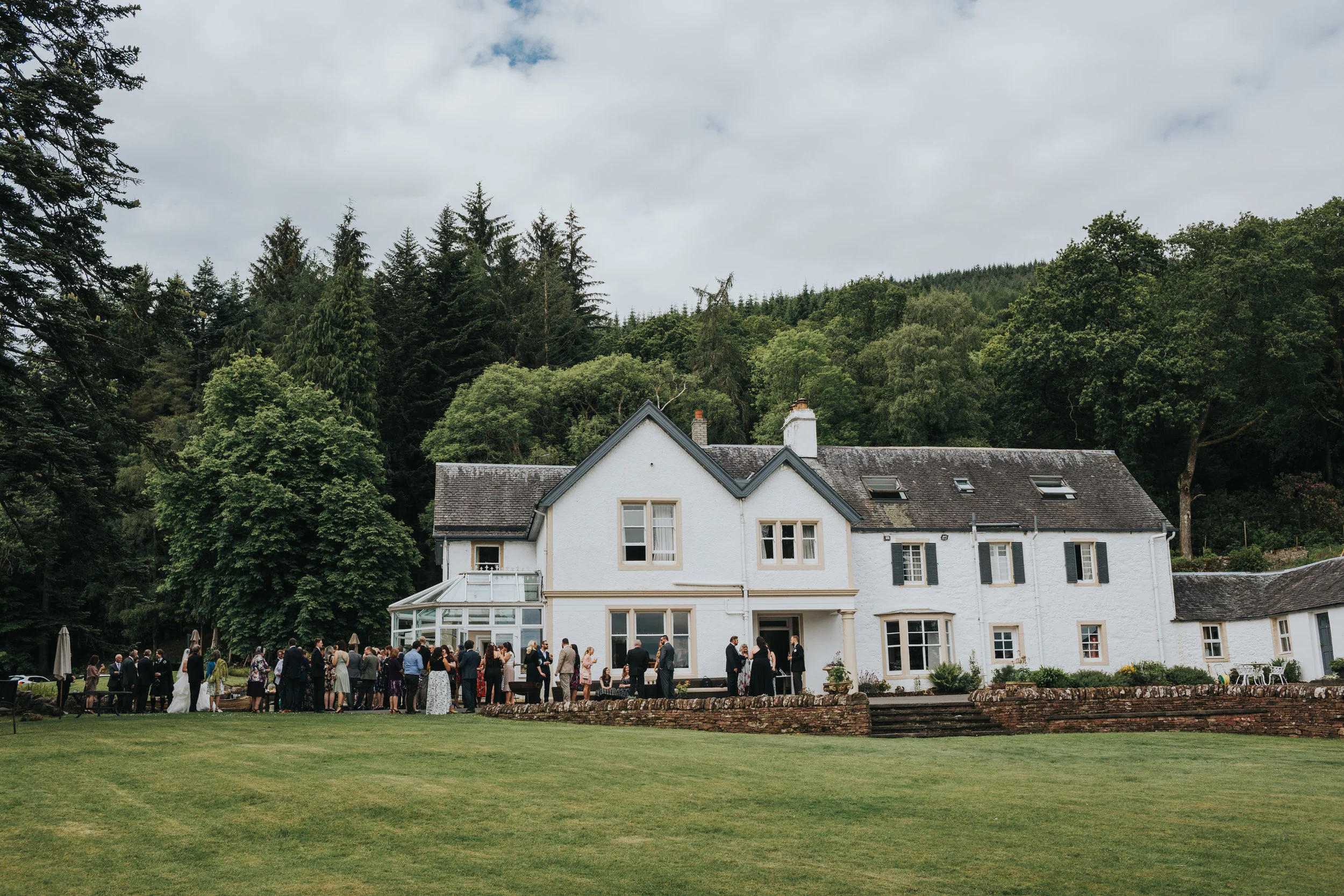 Wedding guests outside Altskeith Country House.