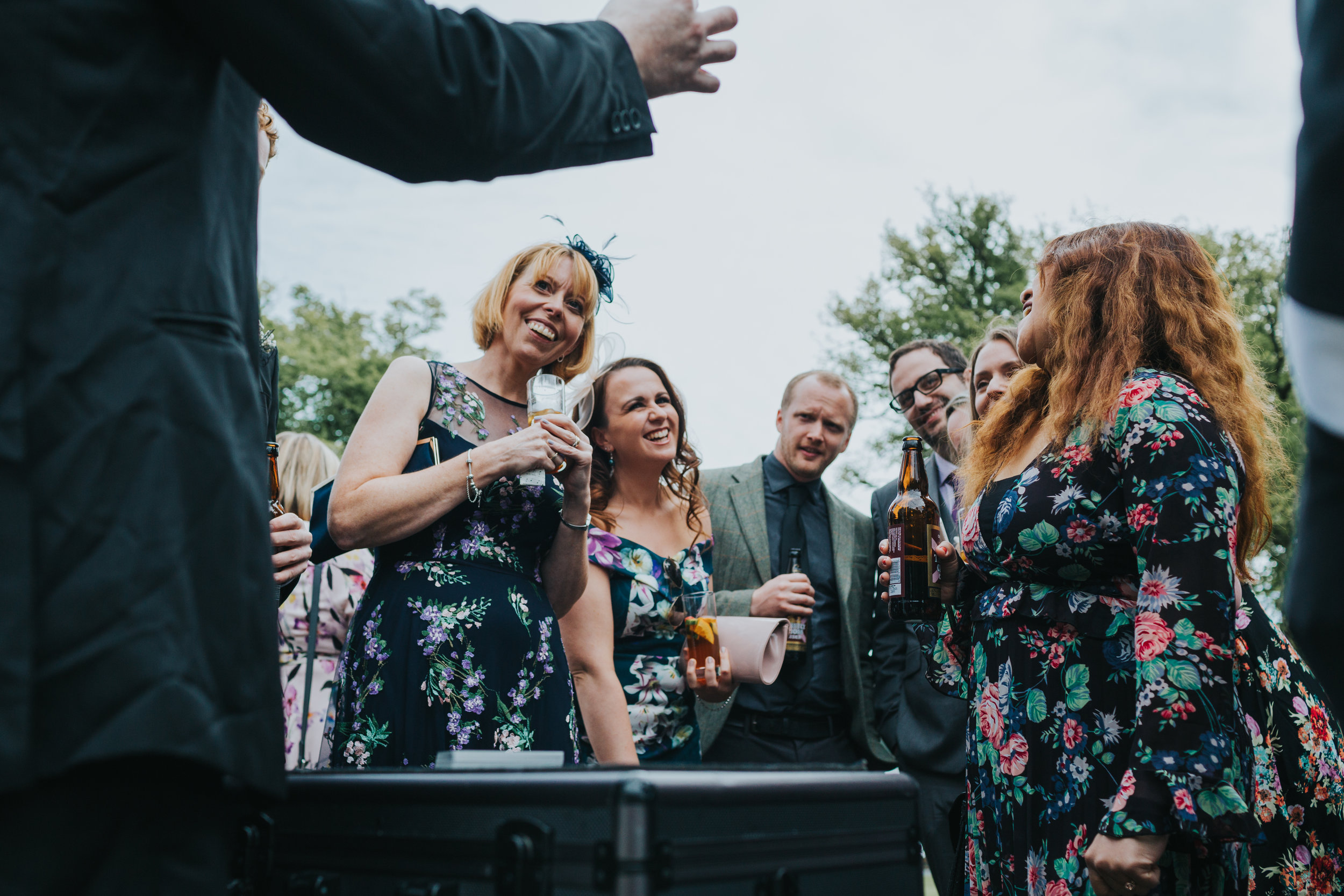 wedding guests watch magic trick. 