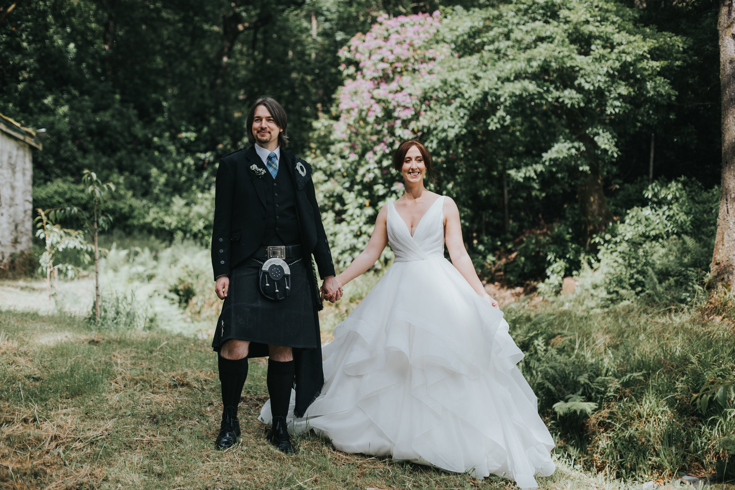 Bride and Groom stand looking proud.