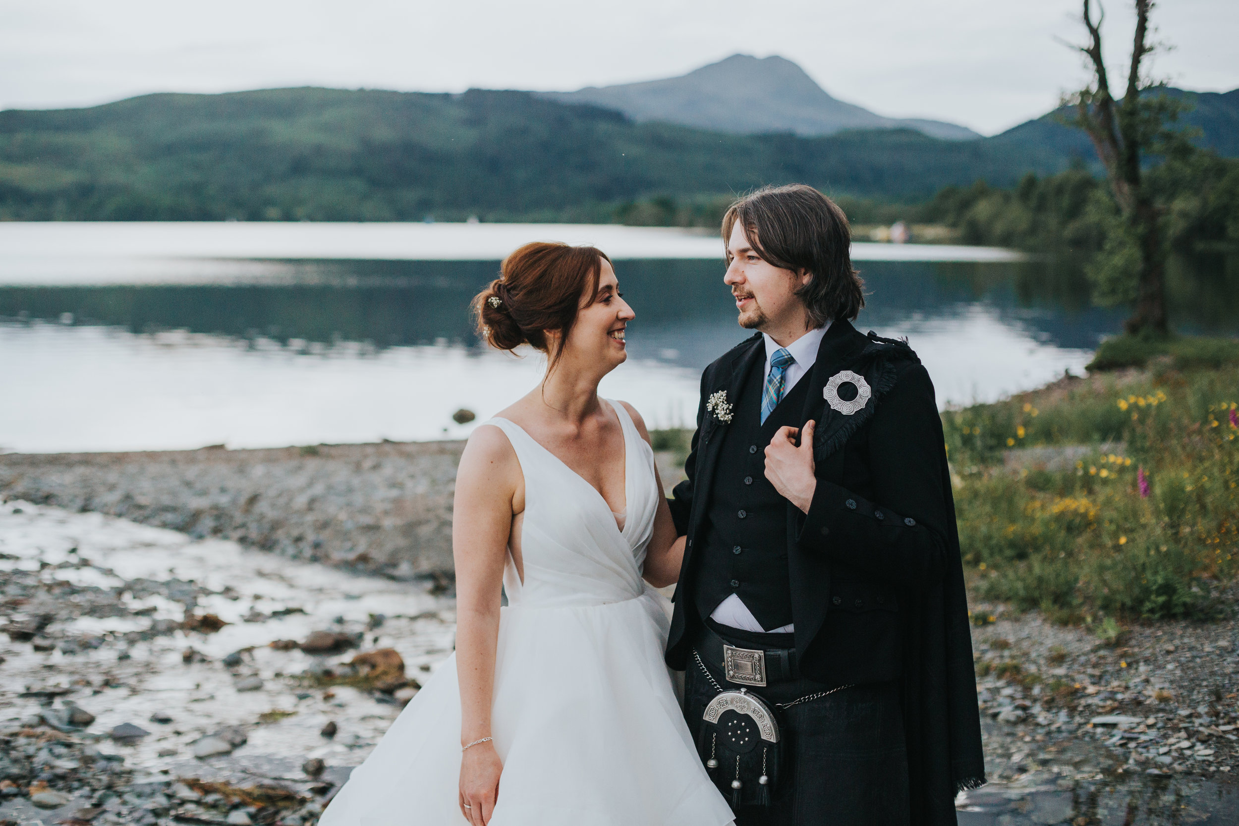 Bride and groom in front of Loch. 