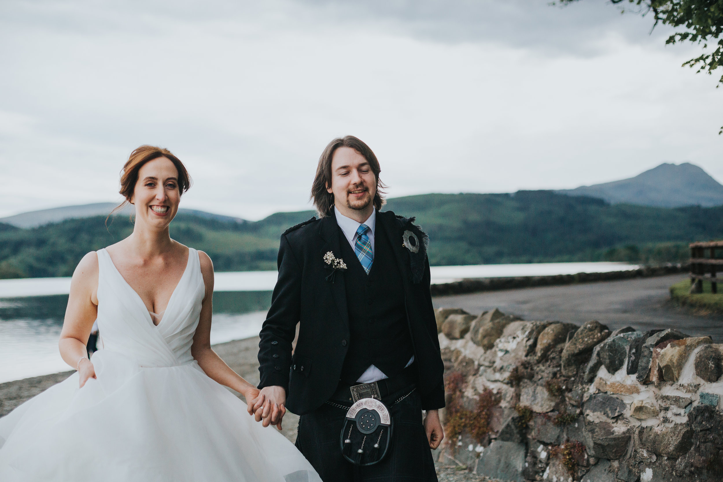 Bride and Groom run across beach laughing.