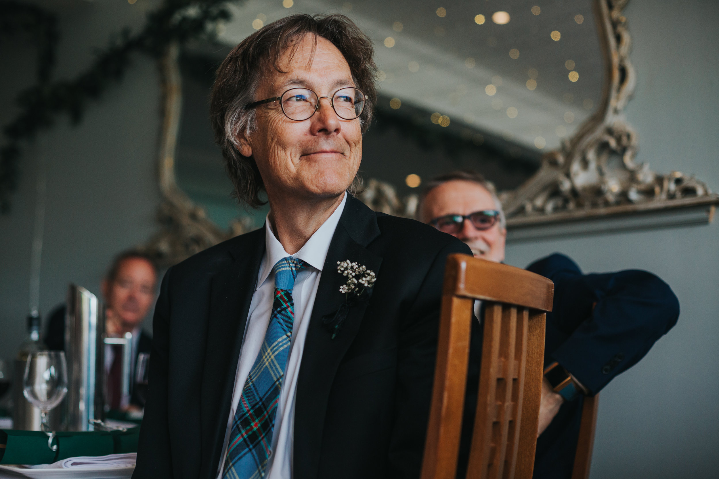 Wedding guest smiles.