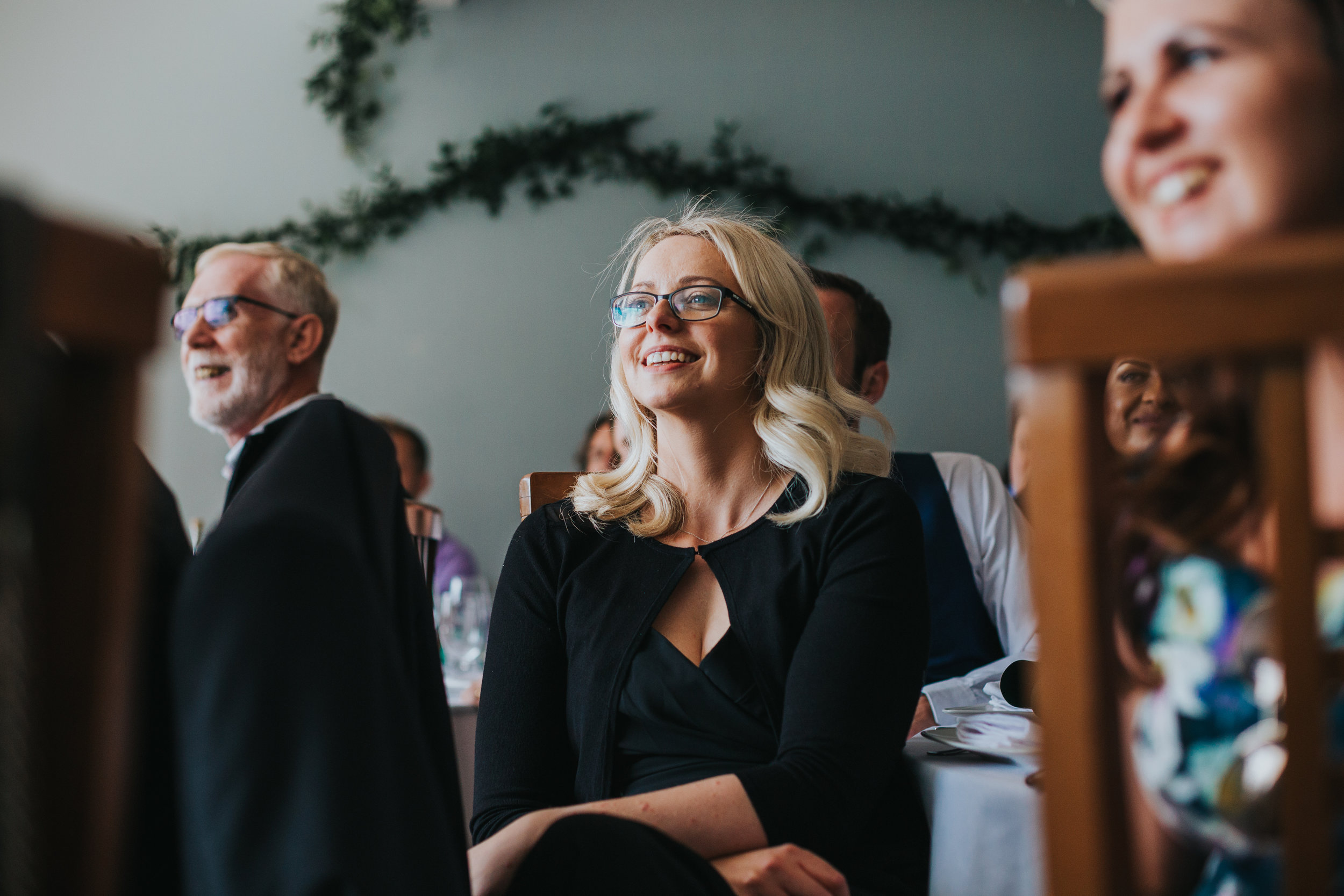 Bridesmaid laughing at speeches. 