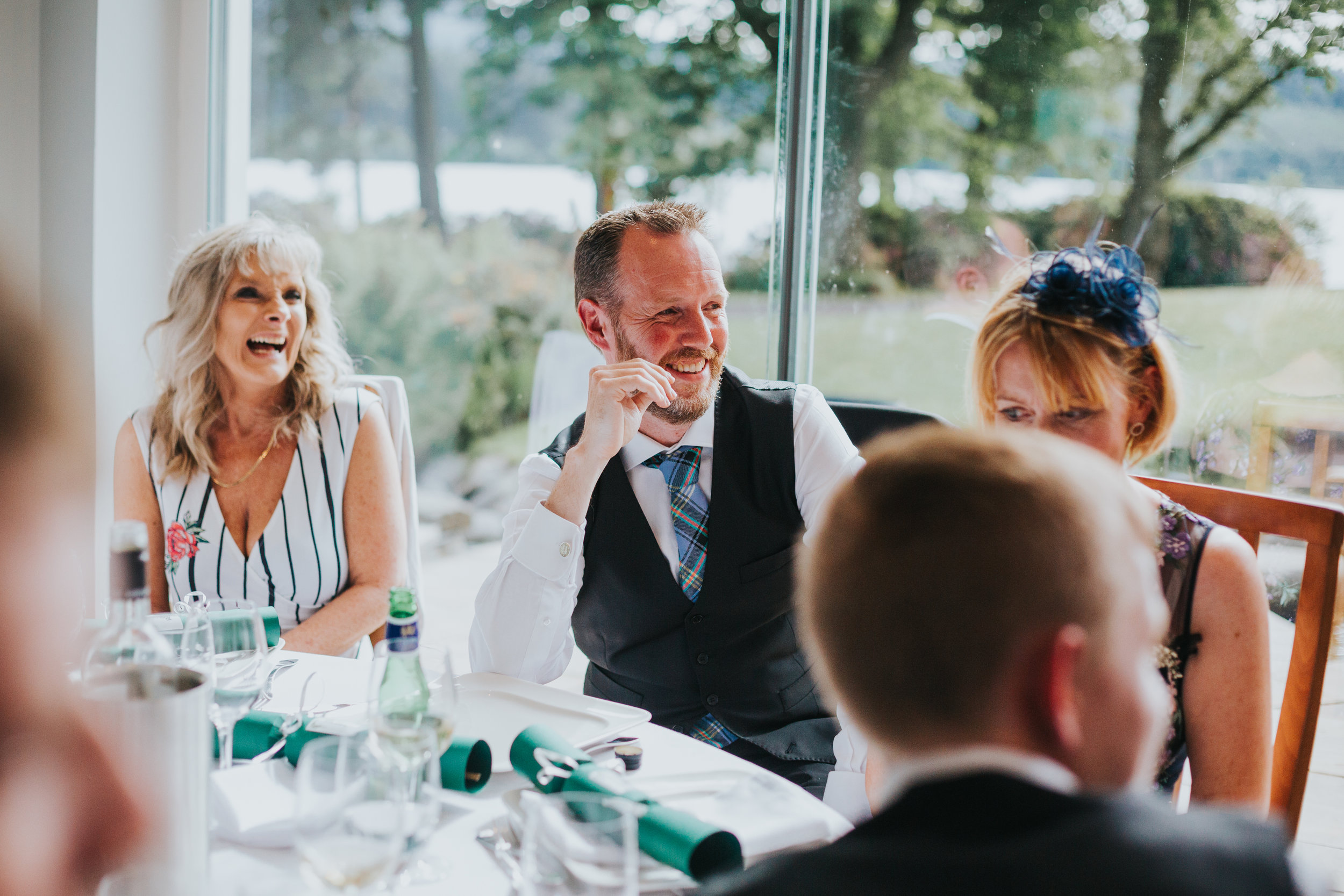 Brother of the Bride laughs at her speech.