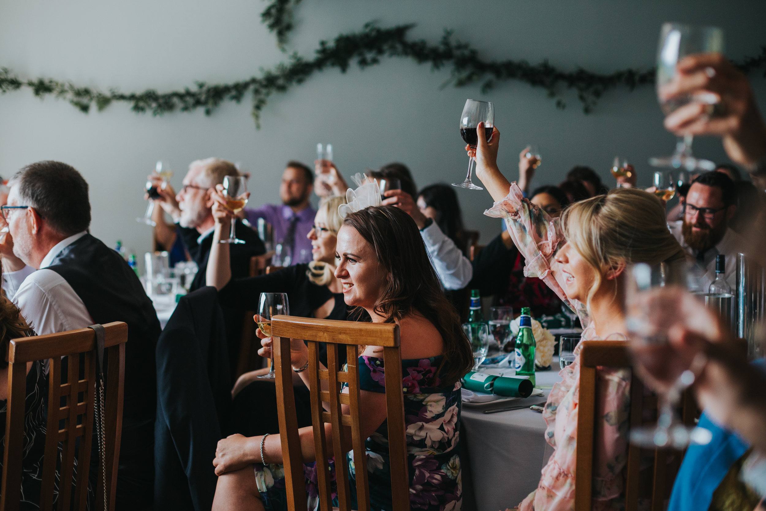 Guests raise their glasses. 