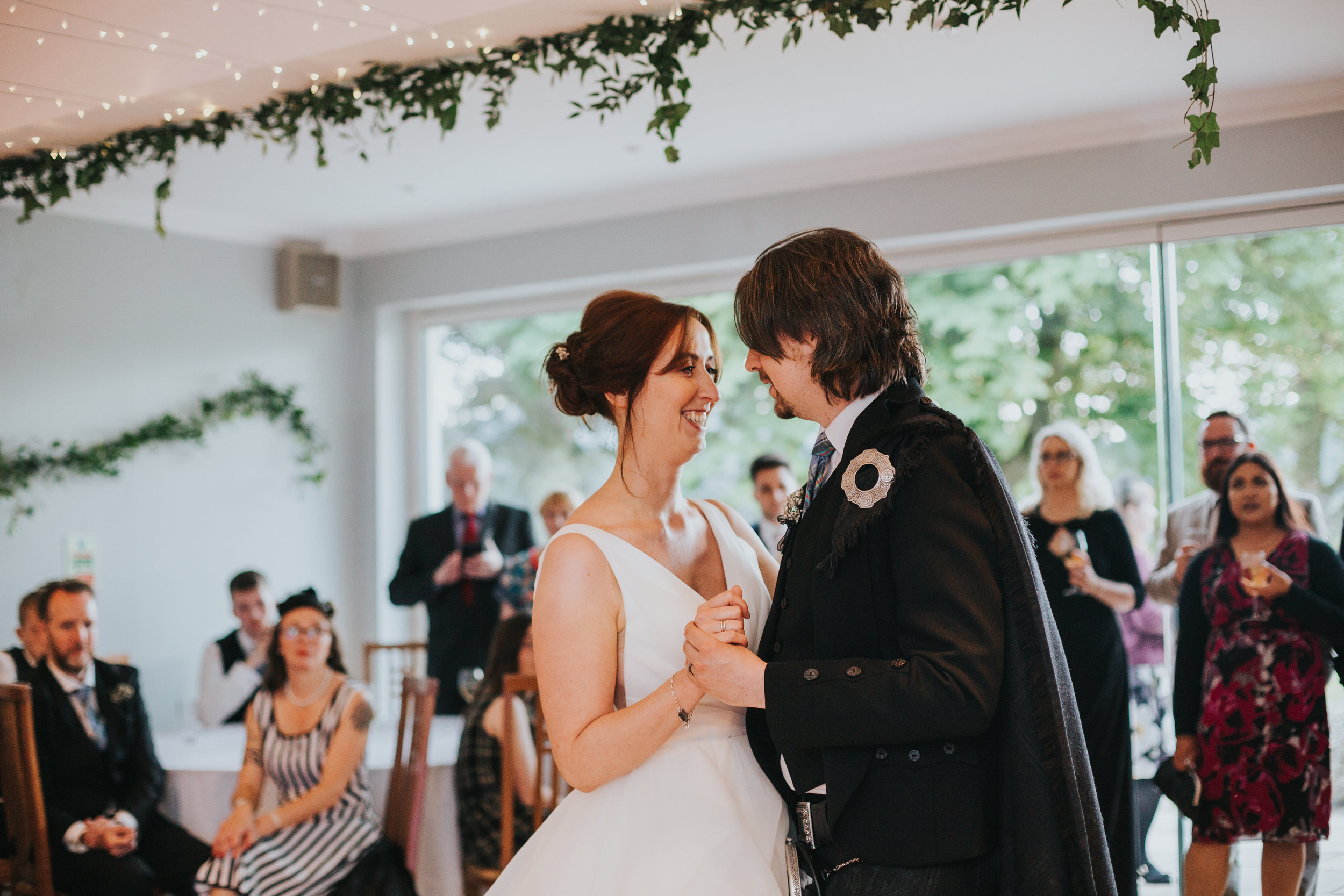 Bride and Groom has first dance in front of their wedding guests at Altskeith Country House, Loch Ard, Scotland.