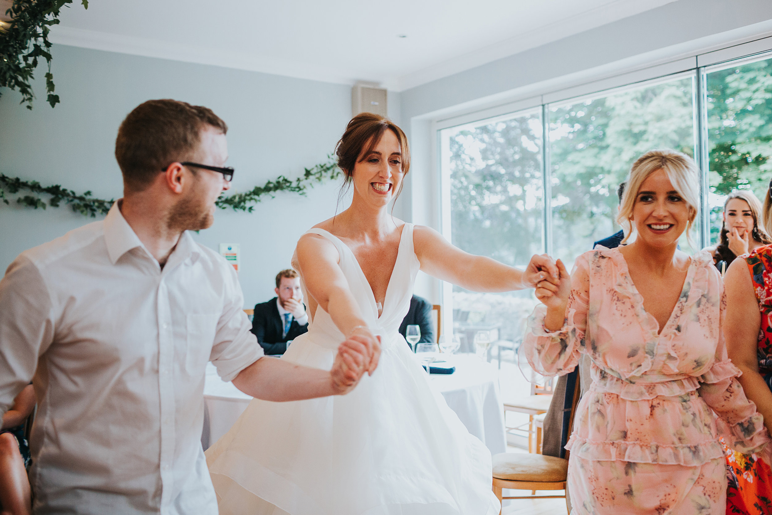Bride dancing with her guests. 