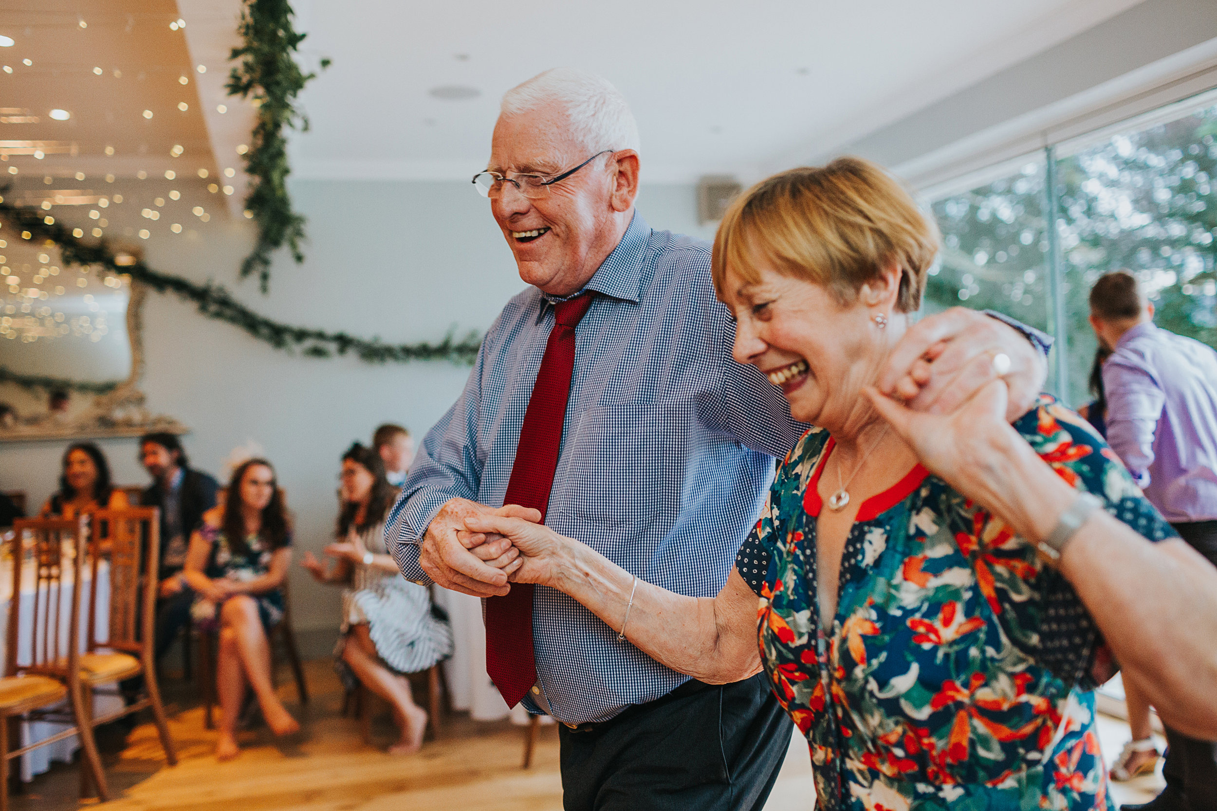 Older couple laughing and dancing together. 