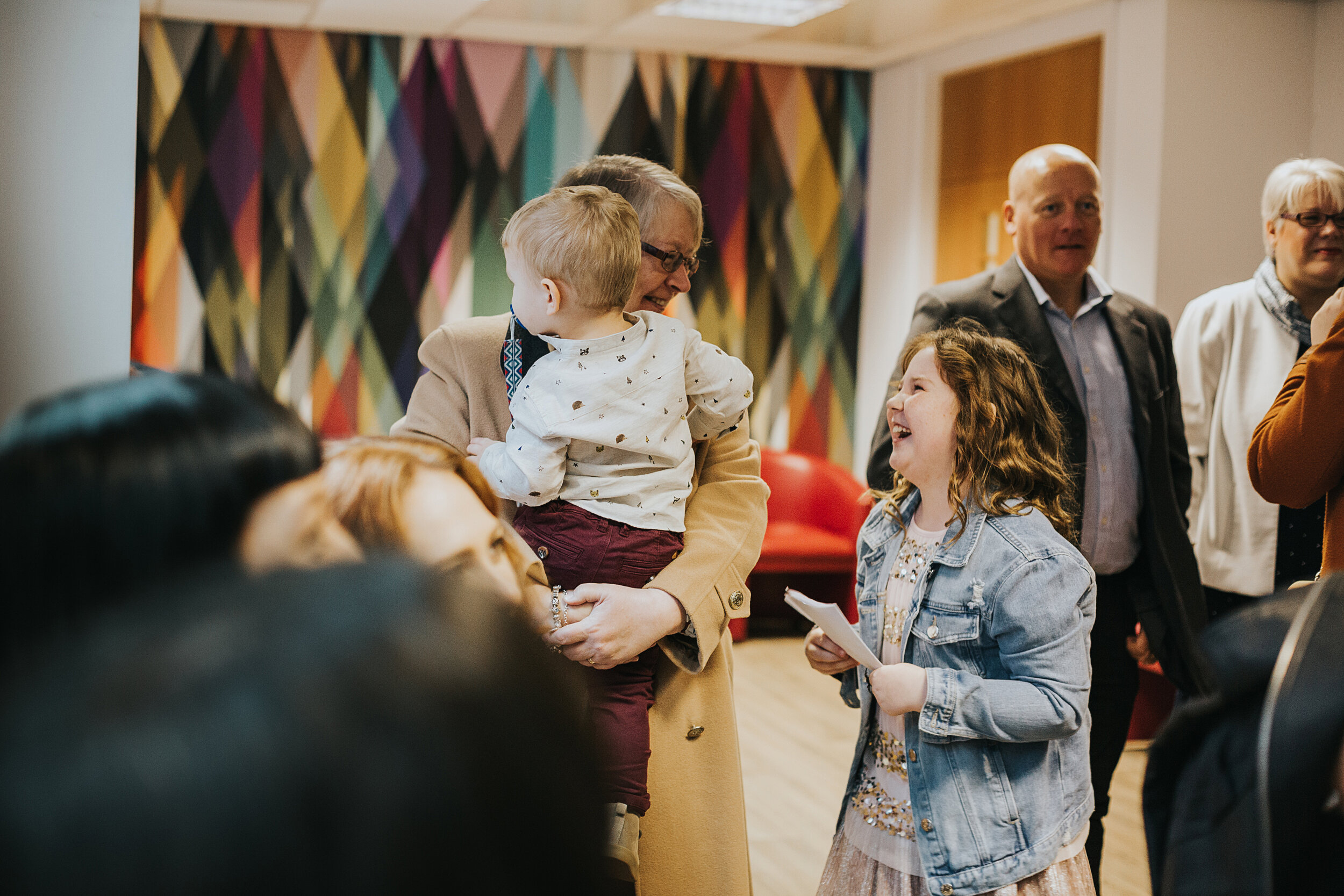 Children greet grandmother in Manchester registry office waiting room.  (Copy)