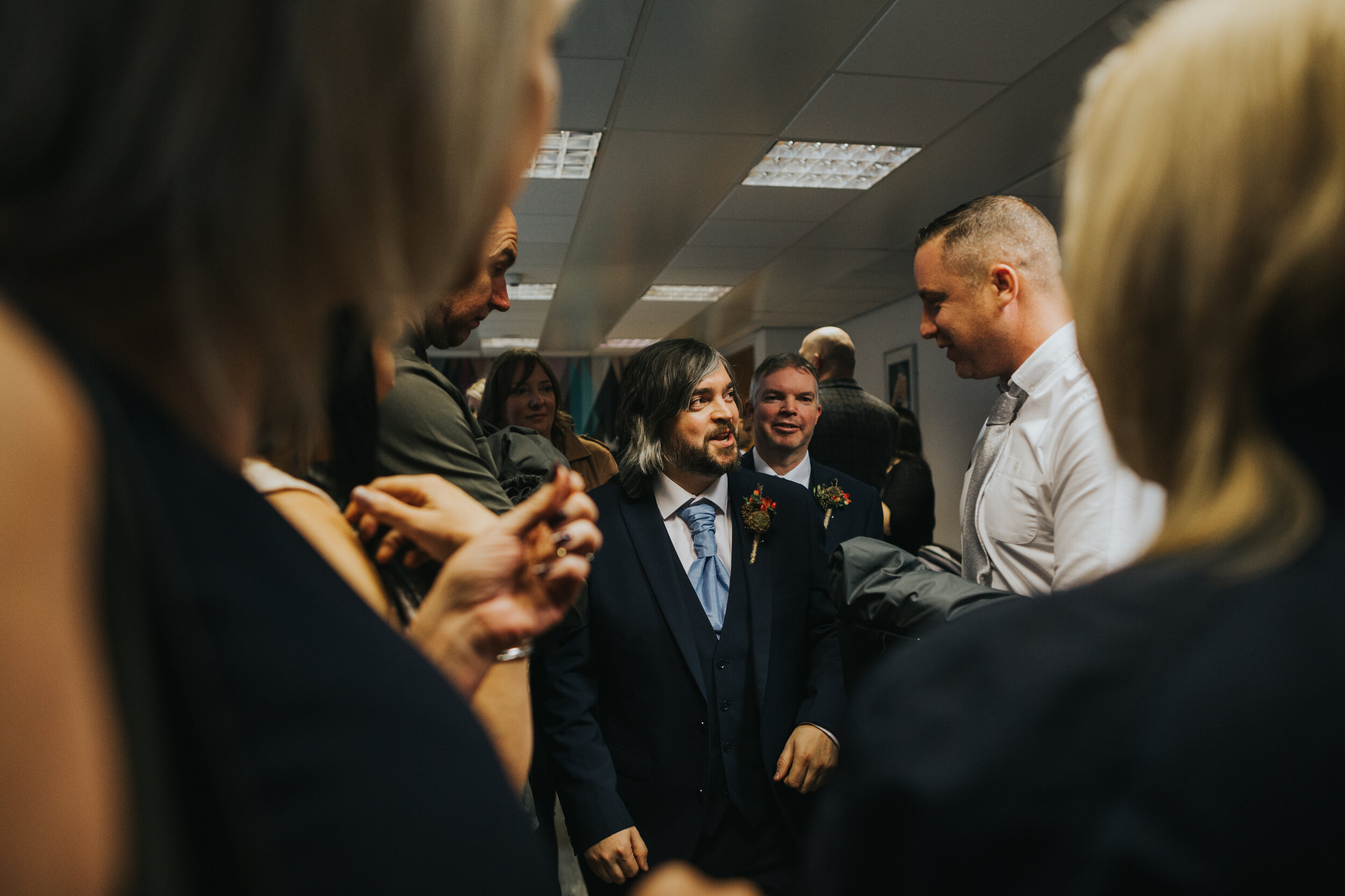 Groom greets guests in the registry office waiting room in Manchester.  (Copy)
