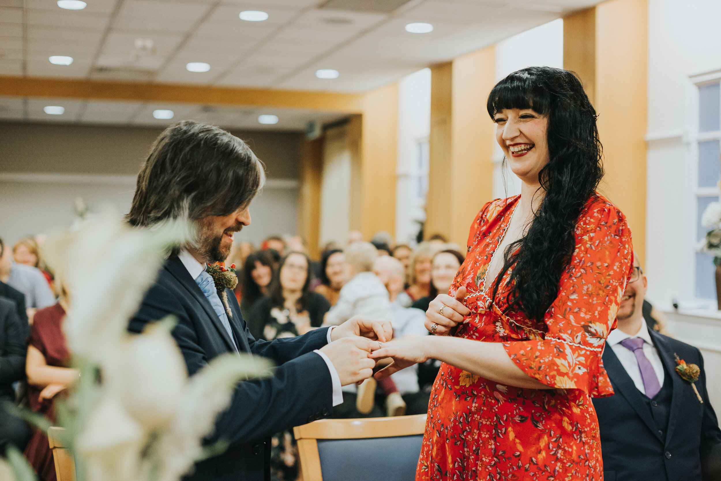 Bride and groom laughing as they put their rings on.  (Copy)