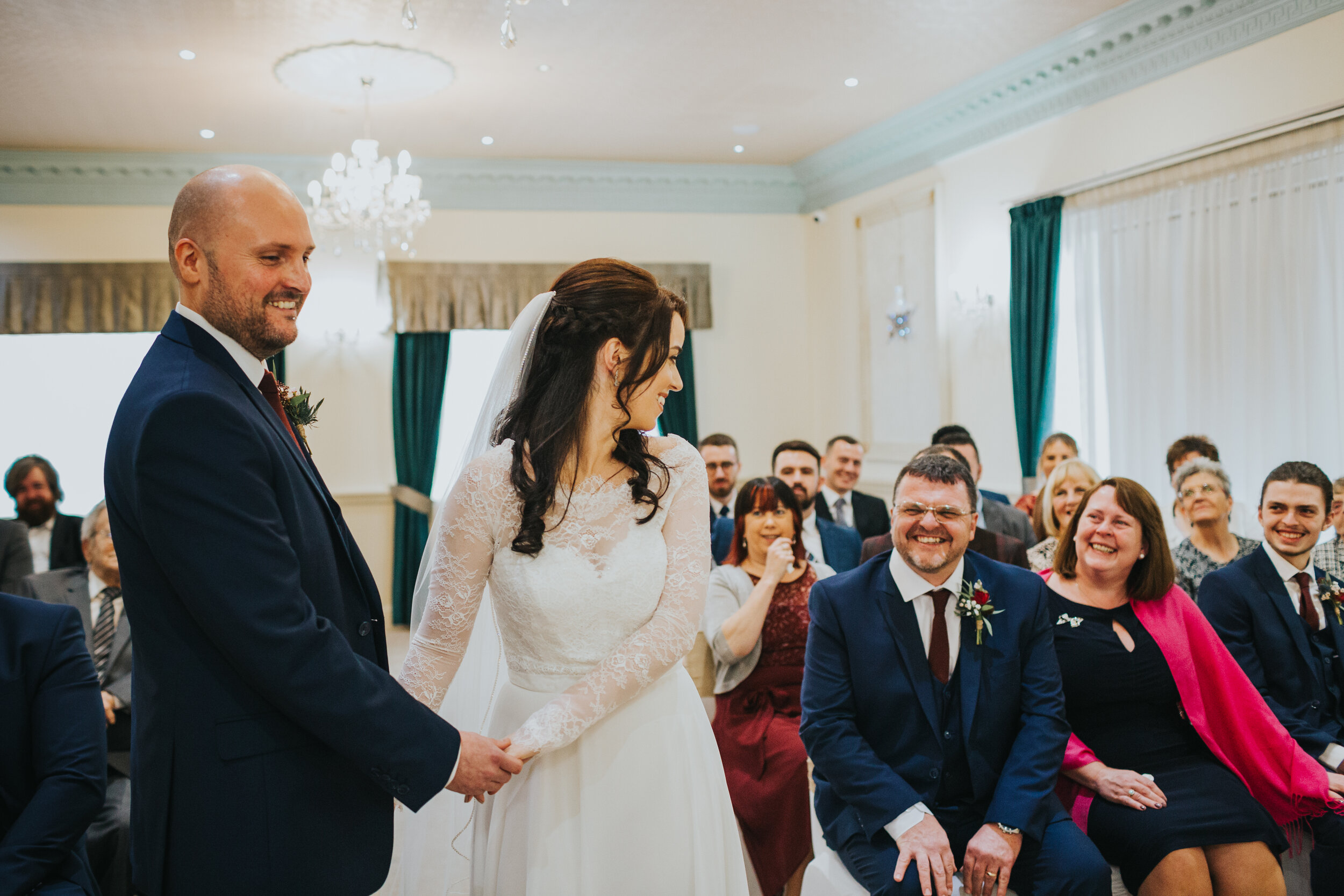 Bride looks back at her father laughing. 