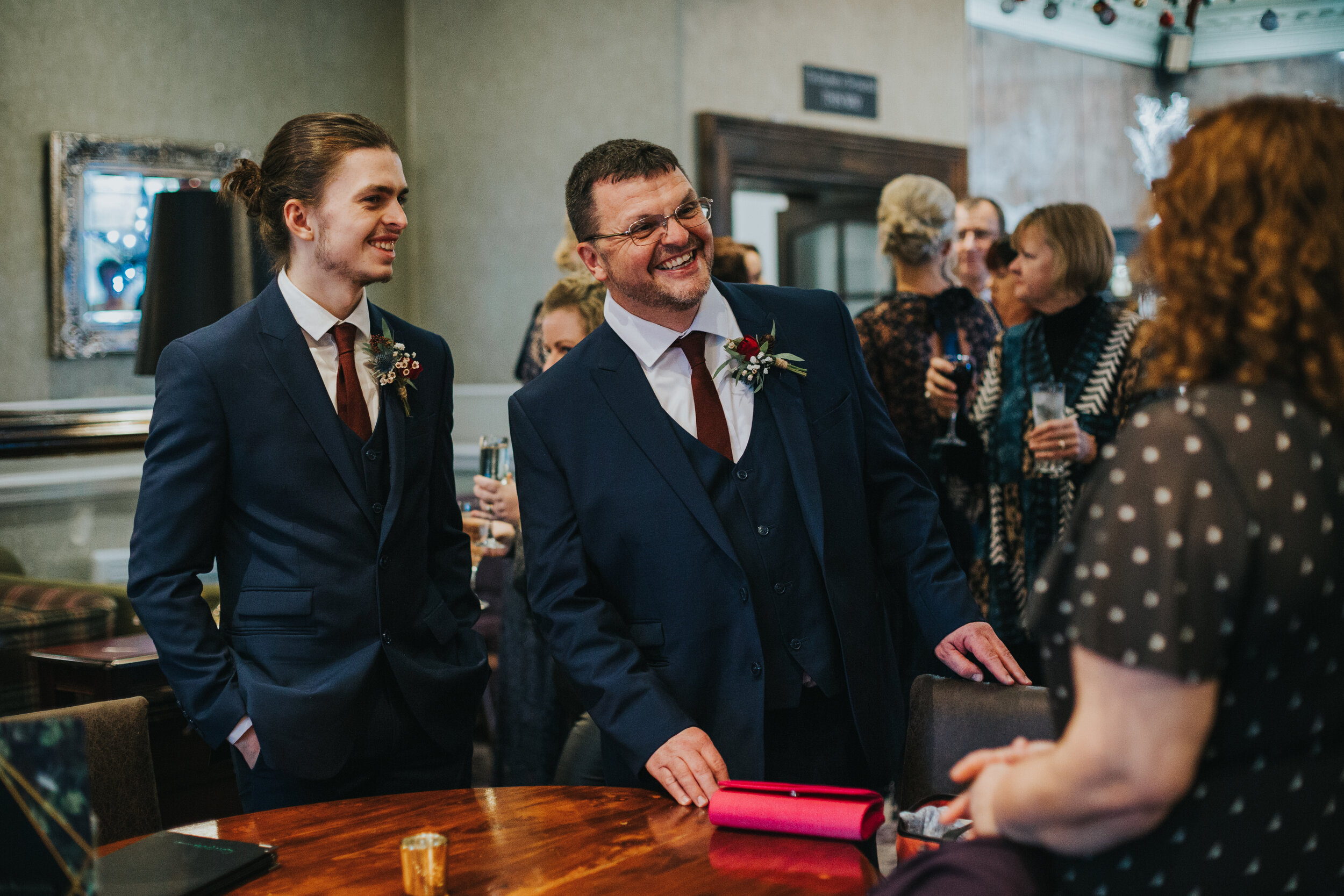 Father and brother of the bride have a good laugh together. 