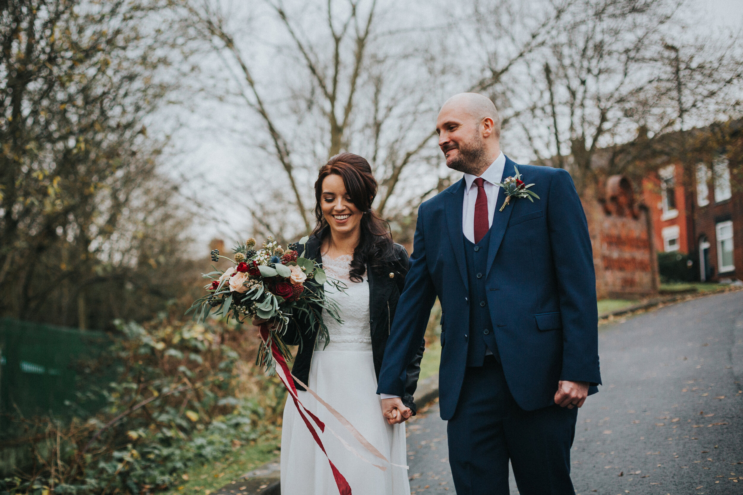 Bride and groom laughing in a natural candid moment together. 