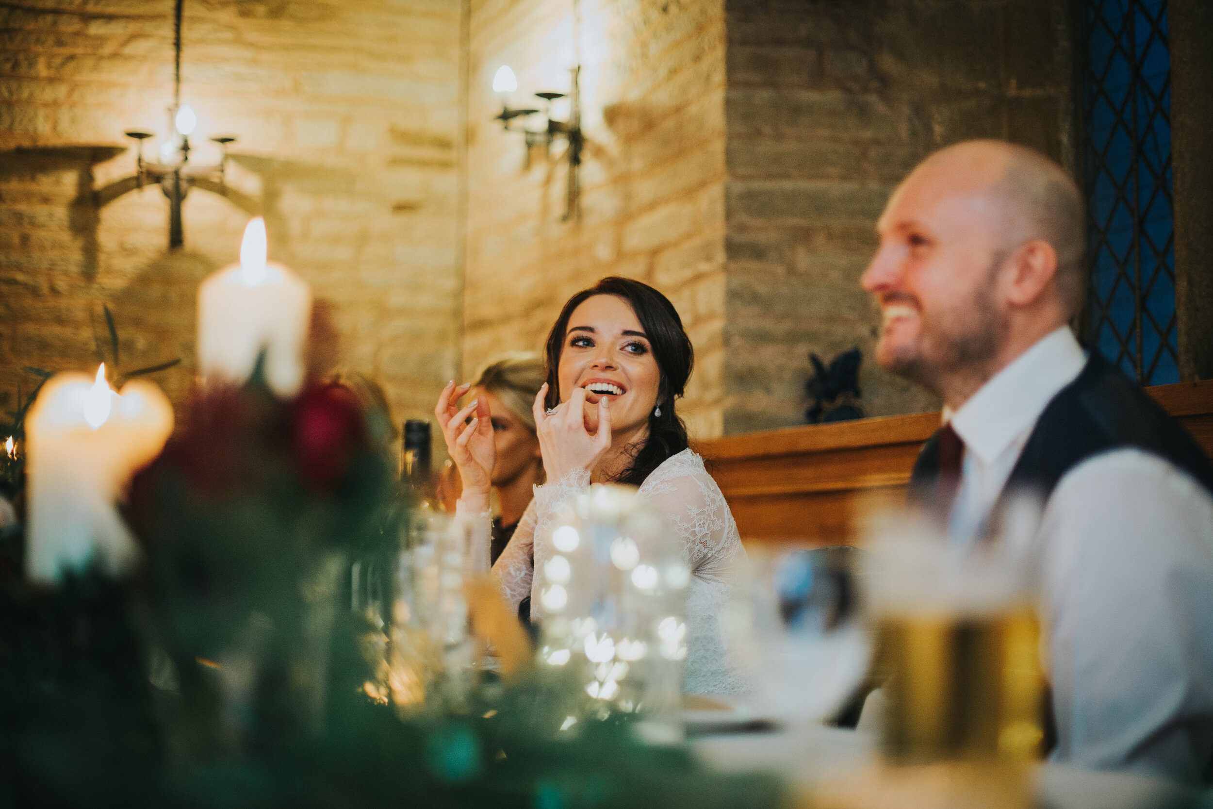 Bride laughs at her fathers speech. 