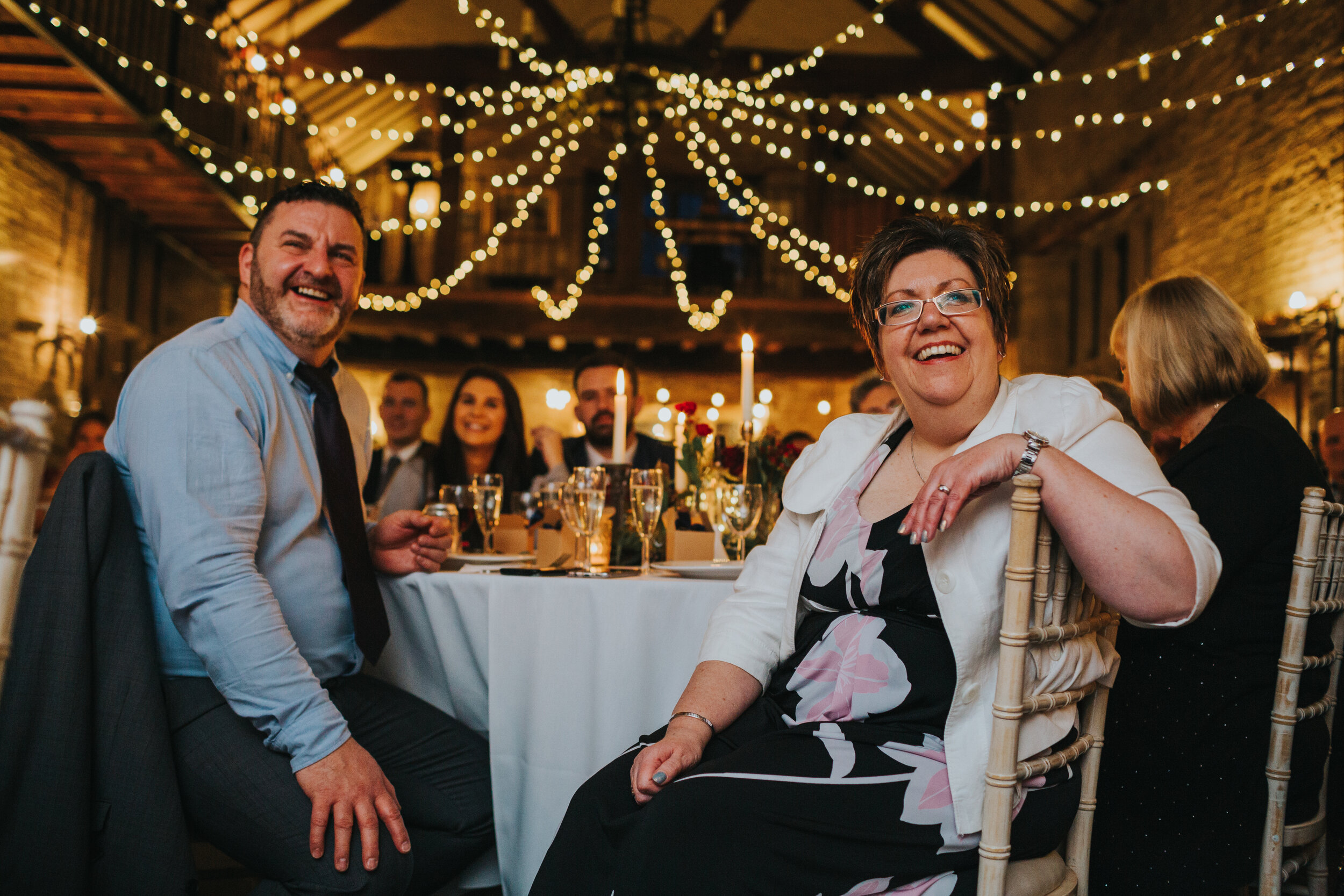 Wedding guests laugh at the speeches at winter wedding.