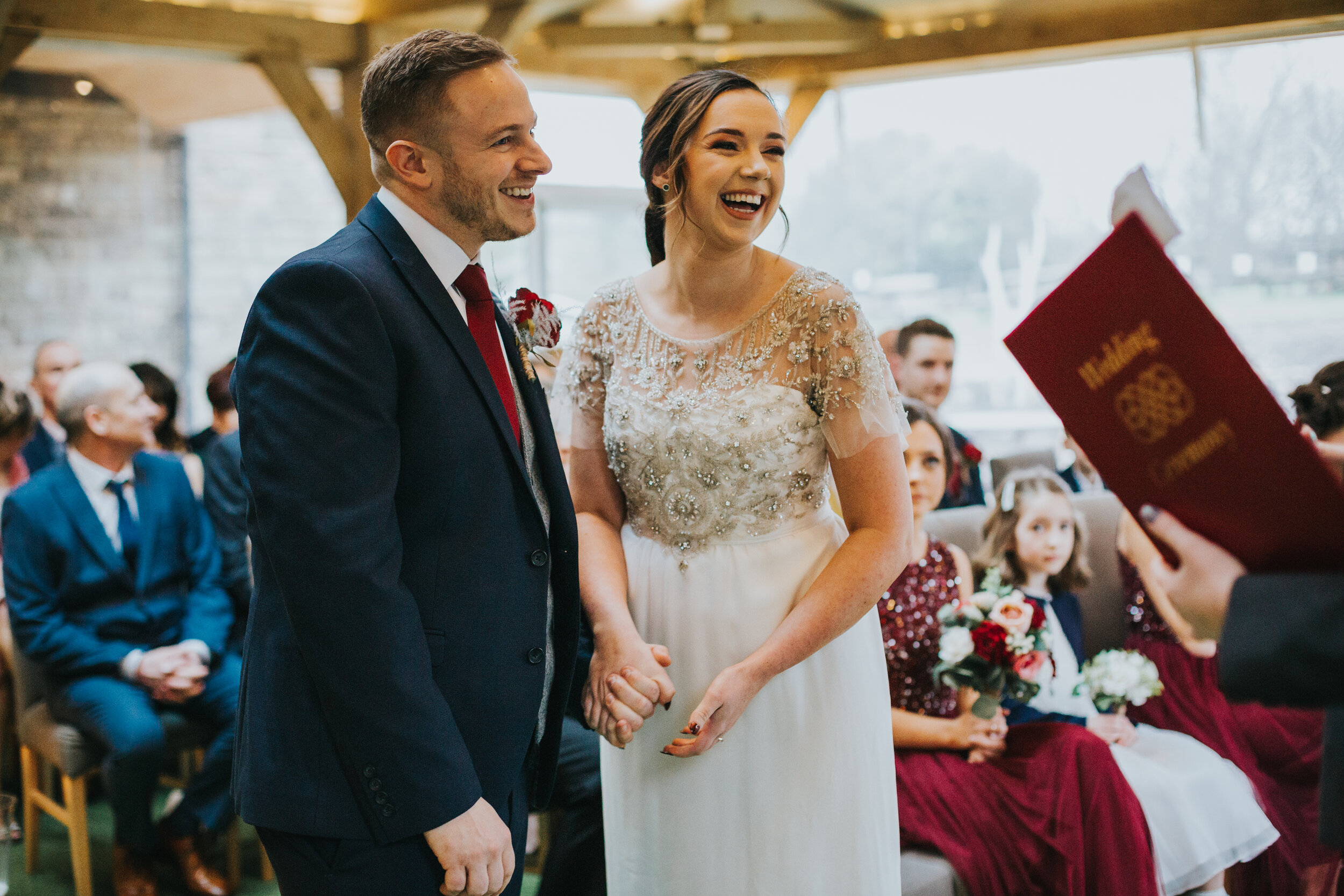 Bride and Groom hold hands. 