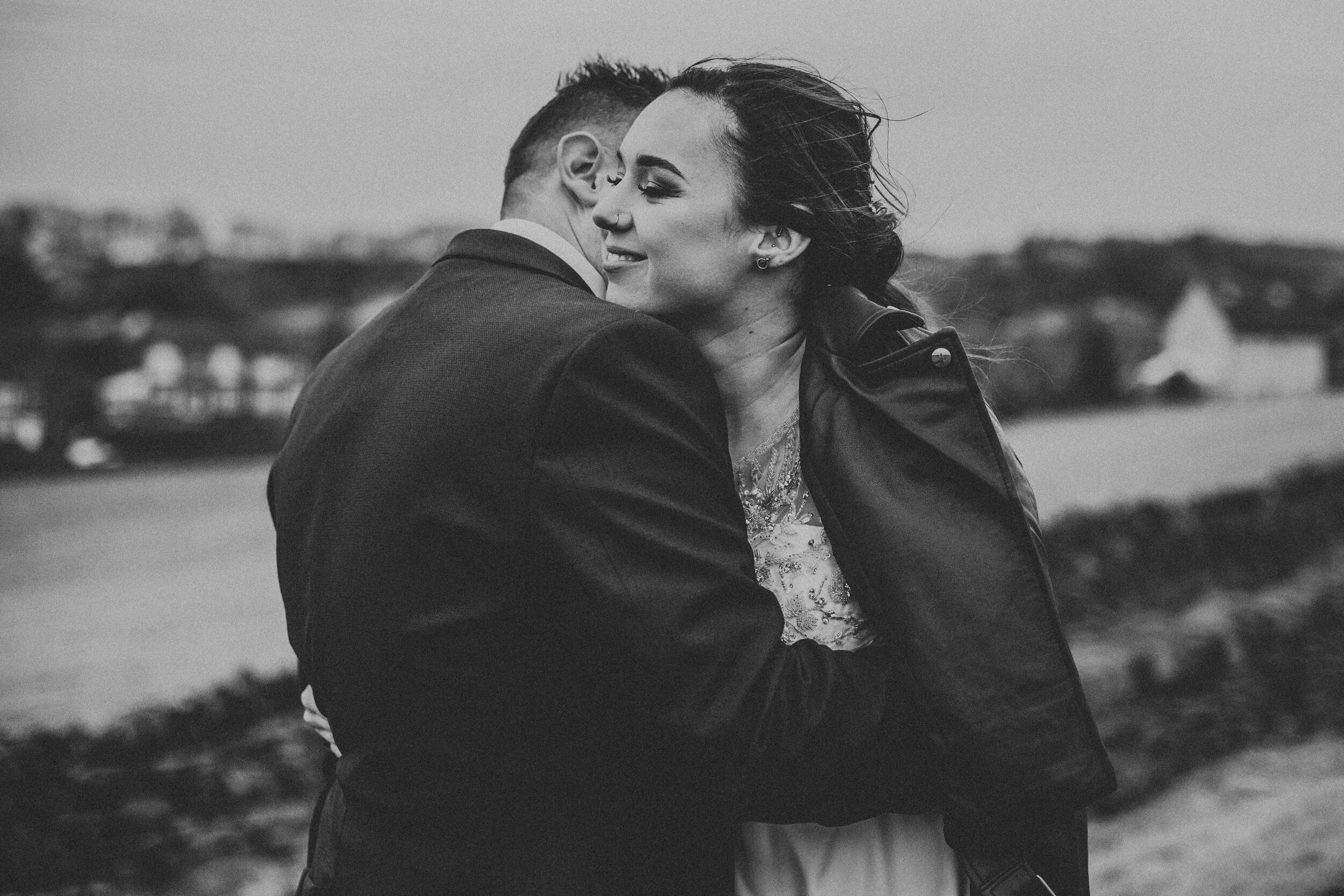 Bride and groom hug, photo in black and white