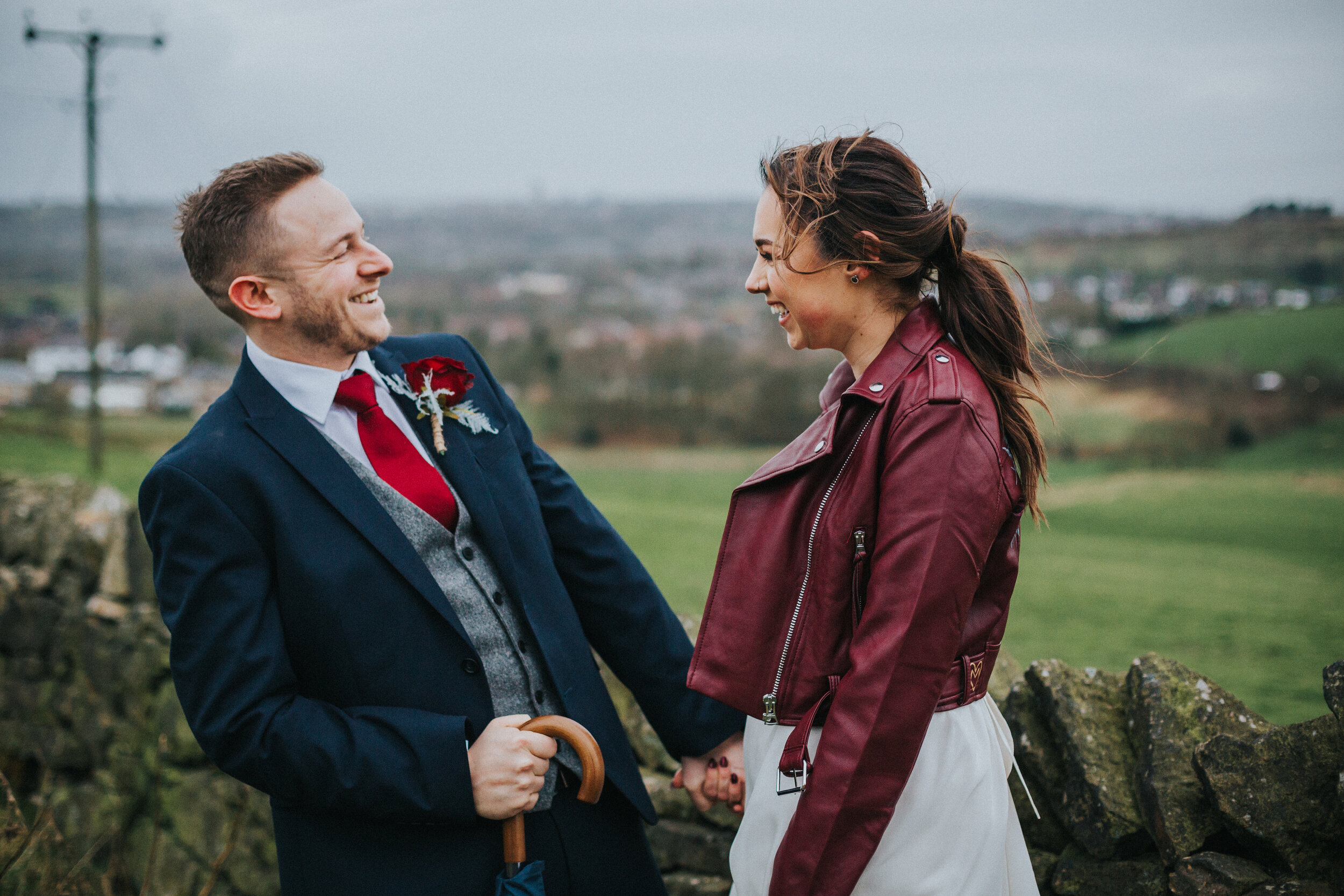 Bride and groom laugh as the storm howls around them