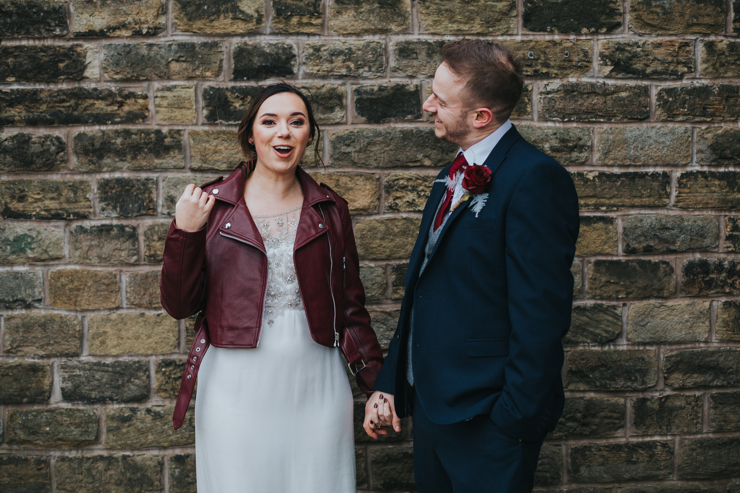 Bride looks shocked as the groom laughs.