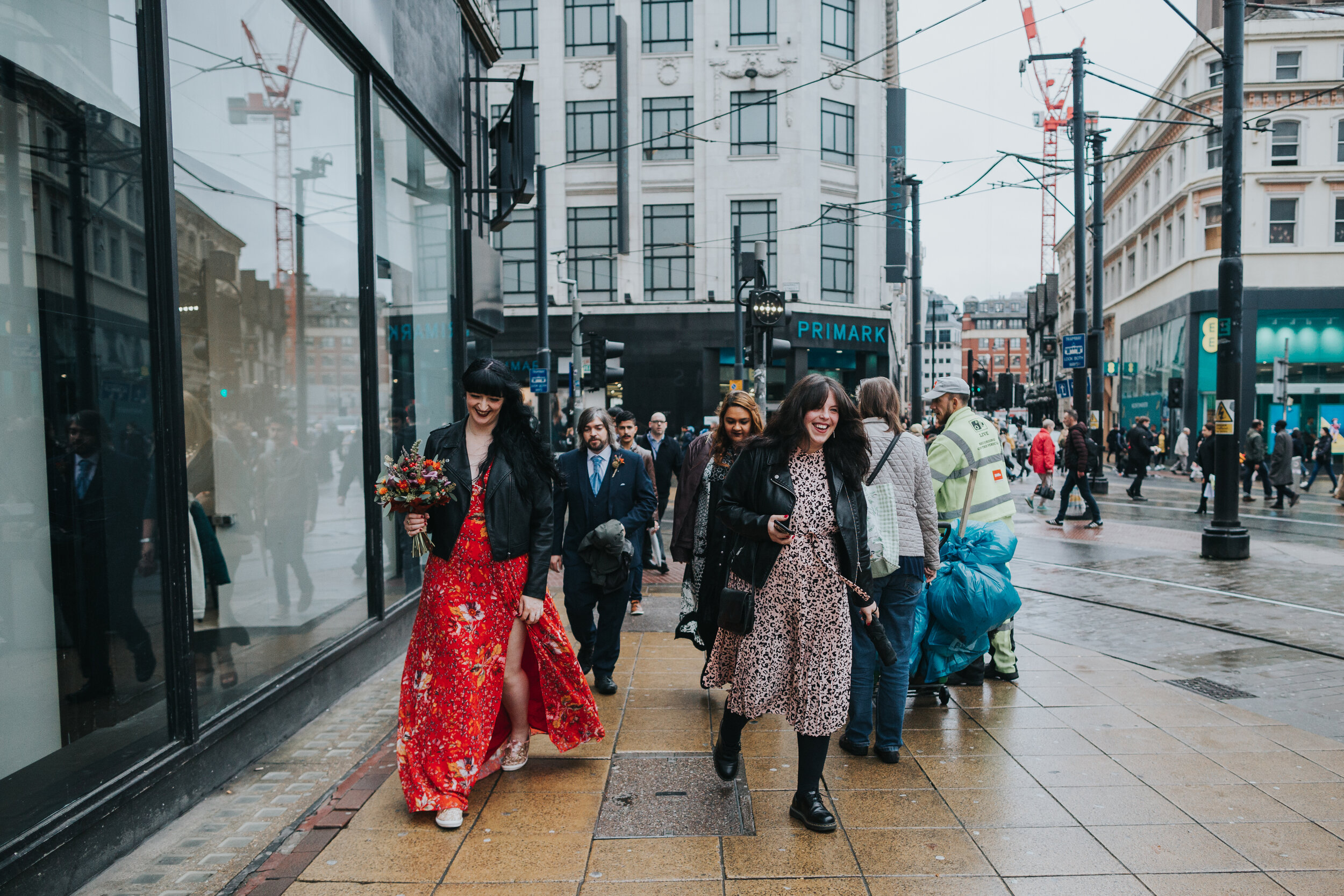 Wedding guests make their way through Manchester city centre.  (Copy)