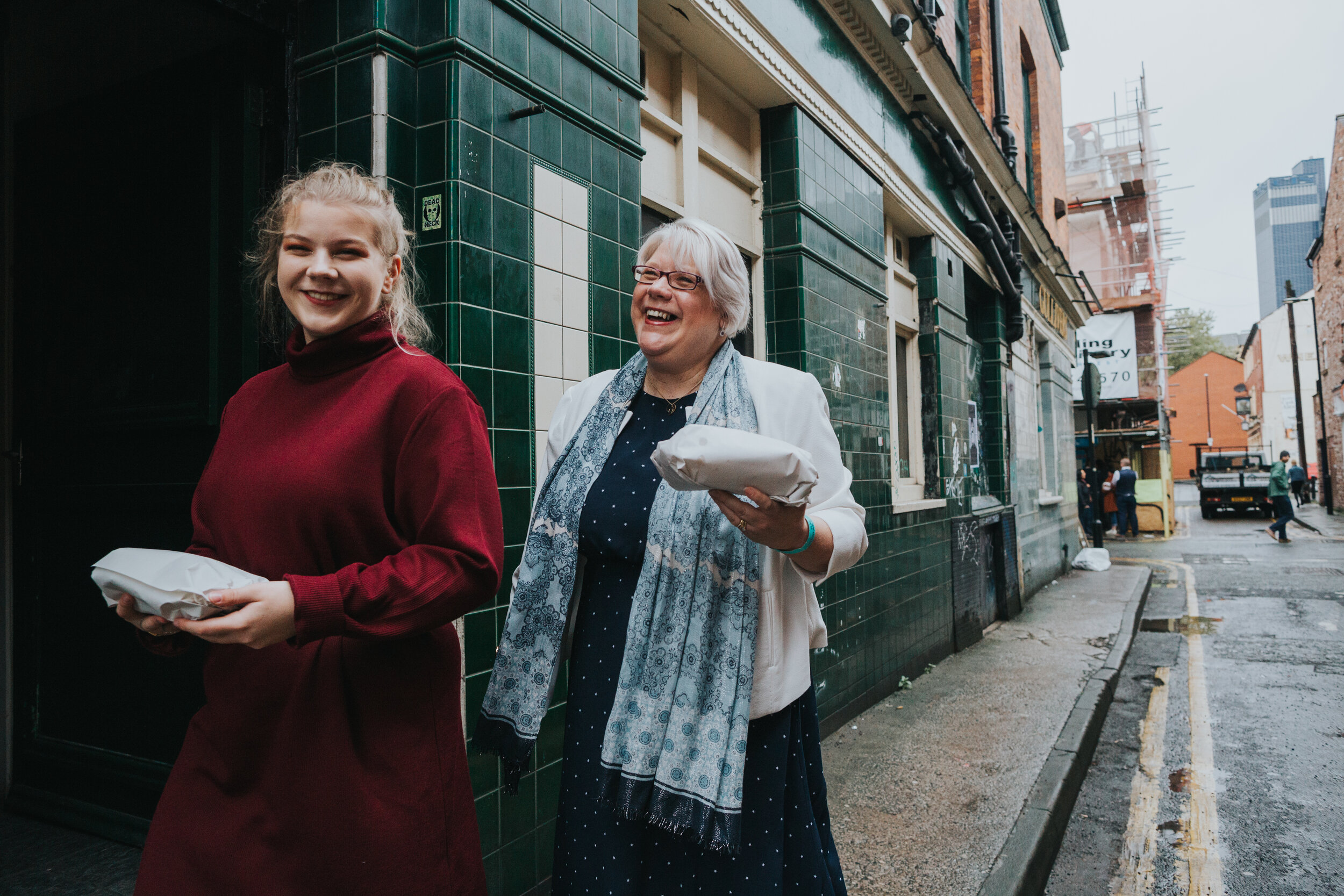 Wedding guests return from the chippy with their fish and chips wrapped in paper.  (Copy)