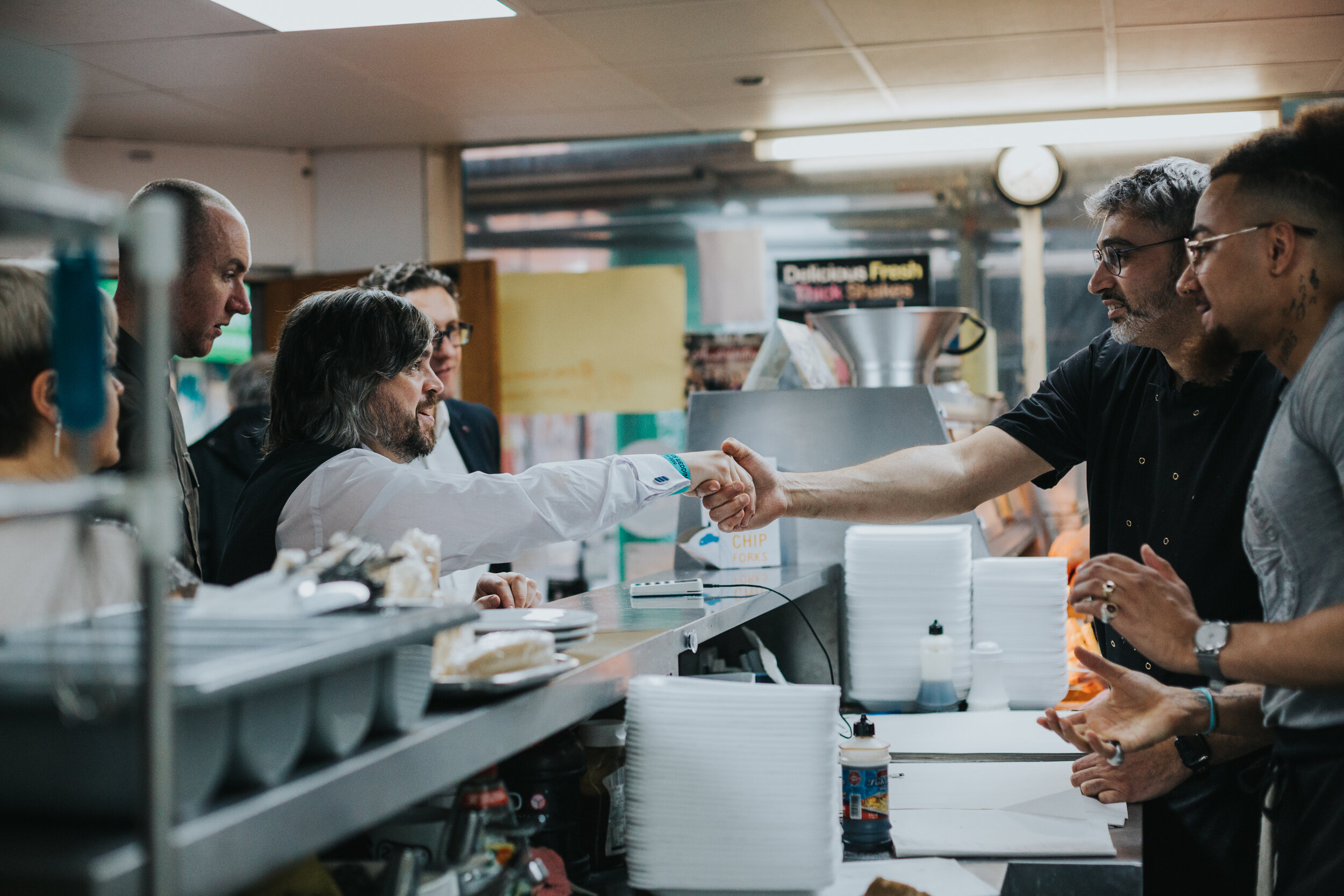 Groom shakes the hand of the chippy manager.  (Copy)