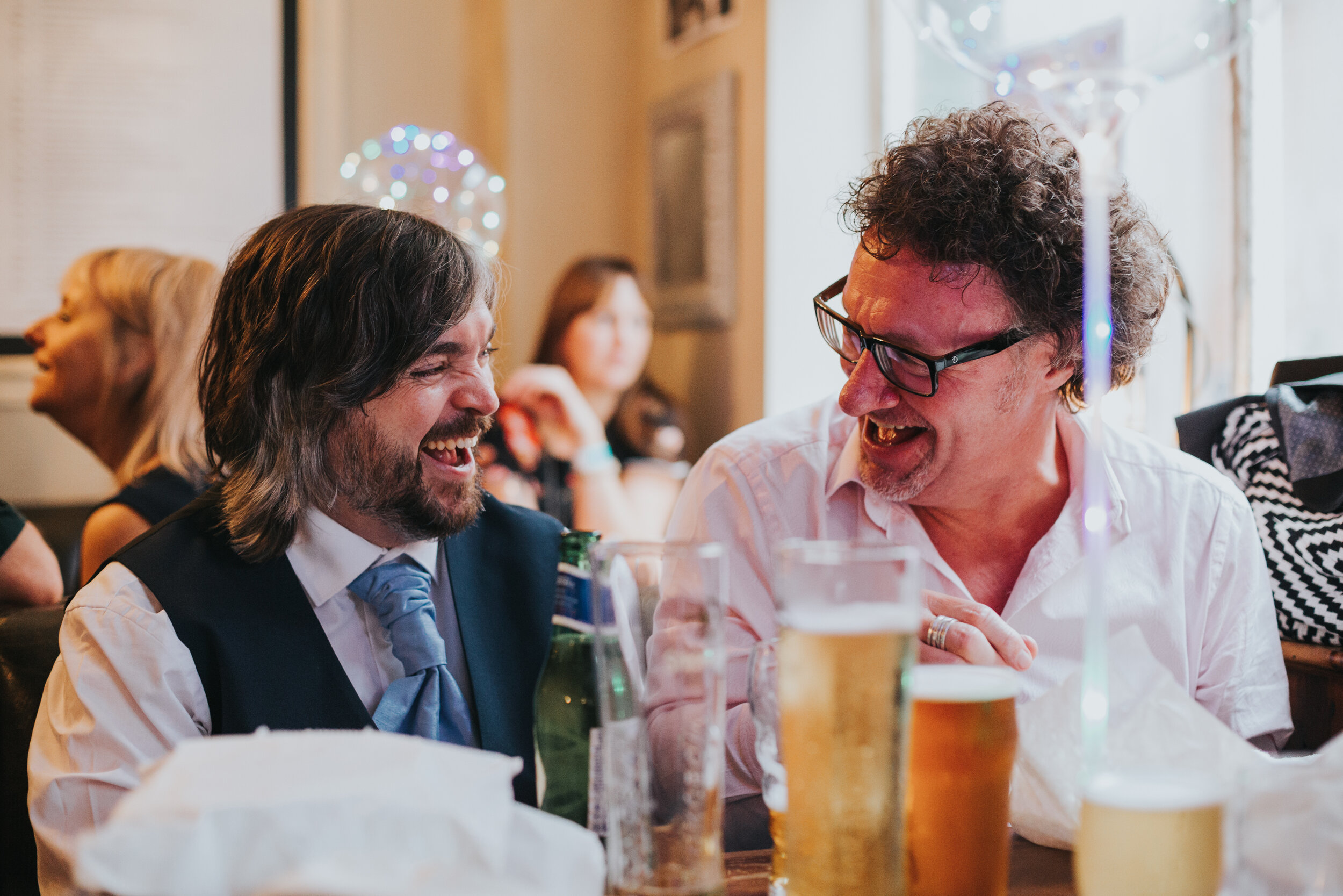 Groom laughing with guest.  (Copy)