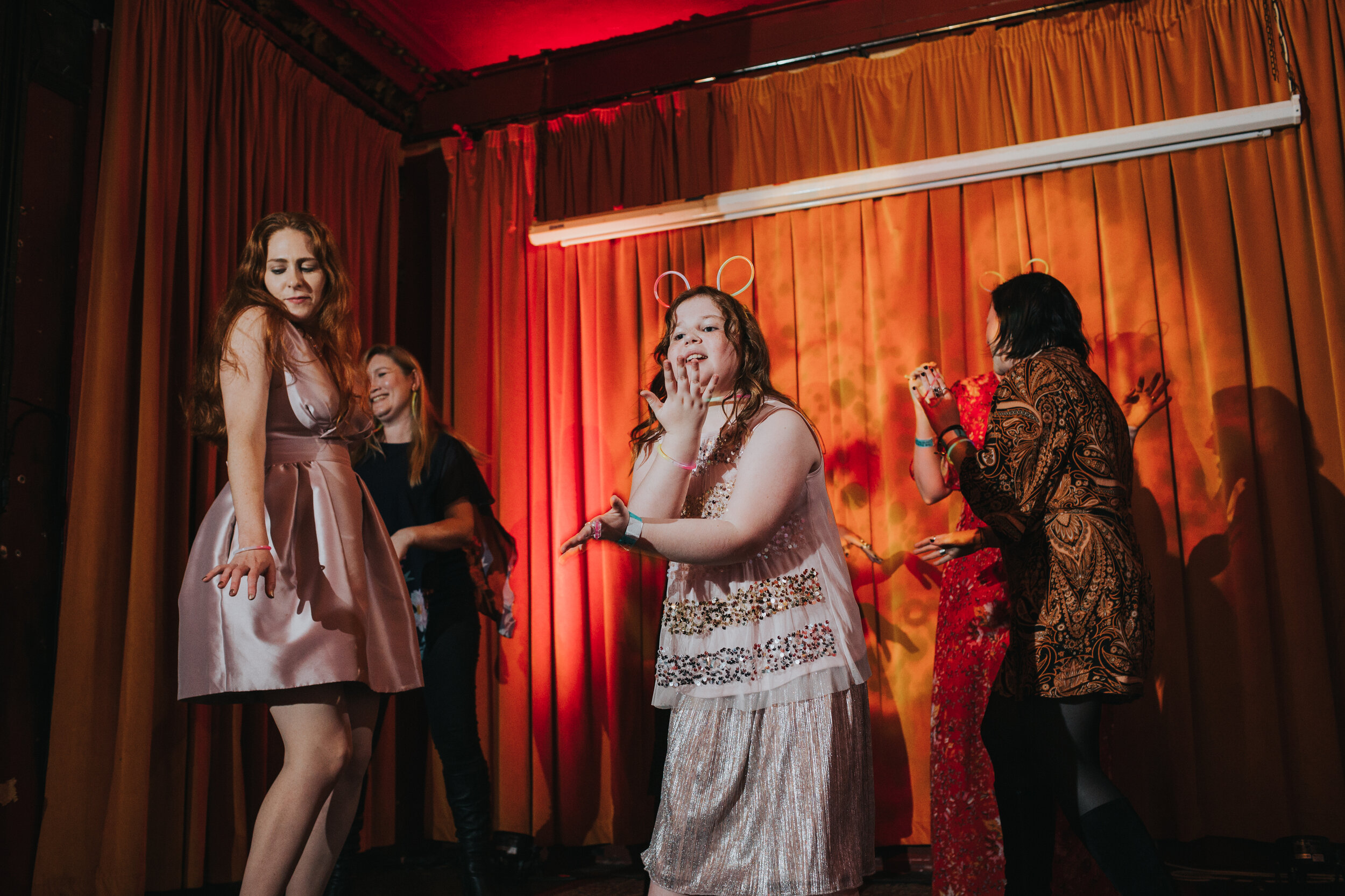 Little girl dancing on stage with wedding guests.  (Copy)