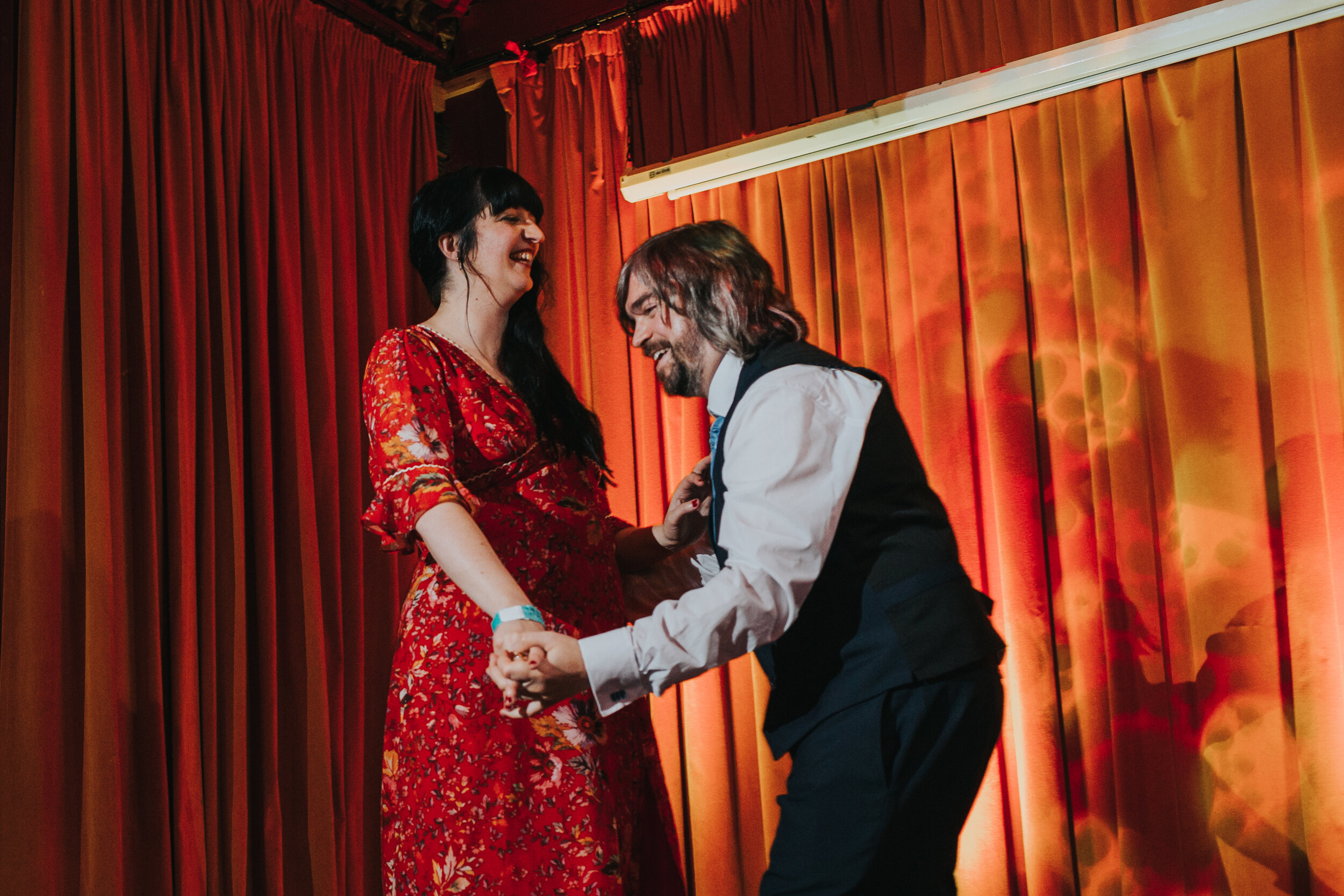 Bride and Groom laughing together as they have their first dance together at their pub wedding in Manchester.  (Copy)