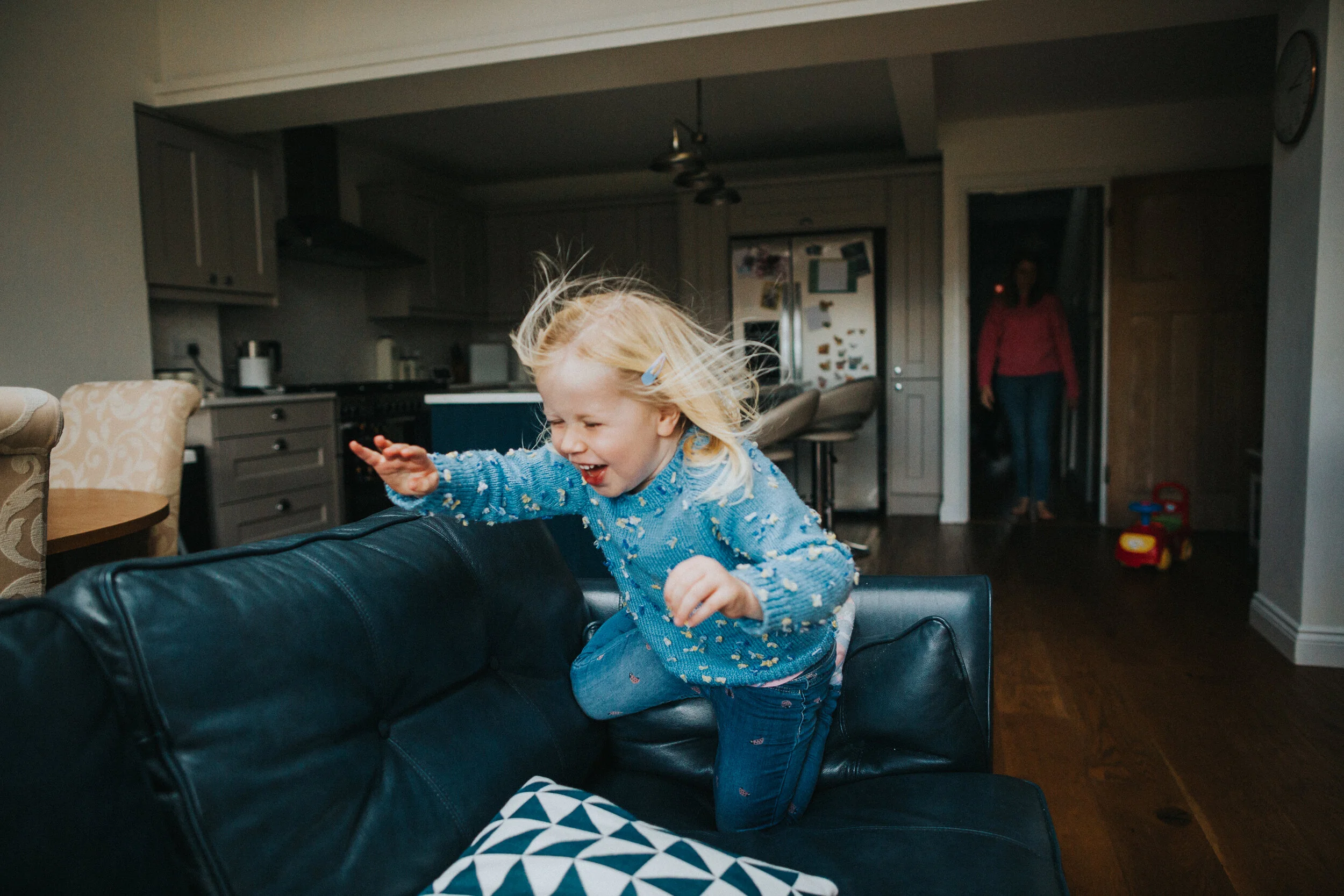 Action shot as little girl jumps. 