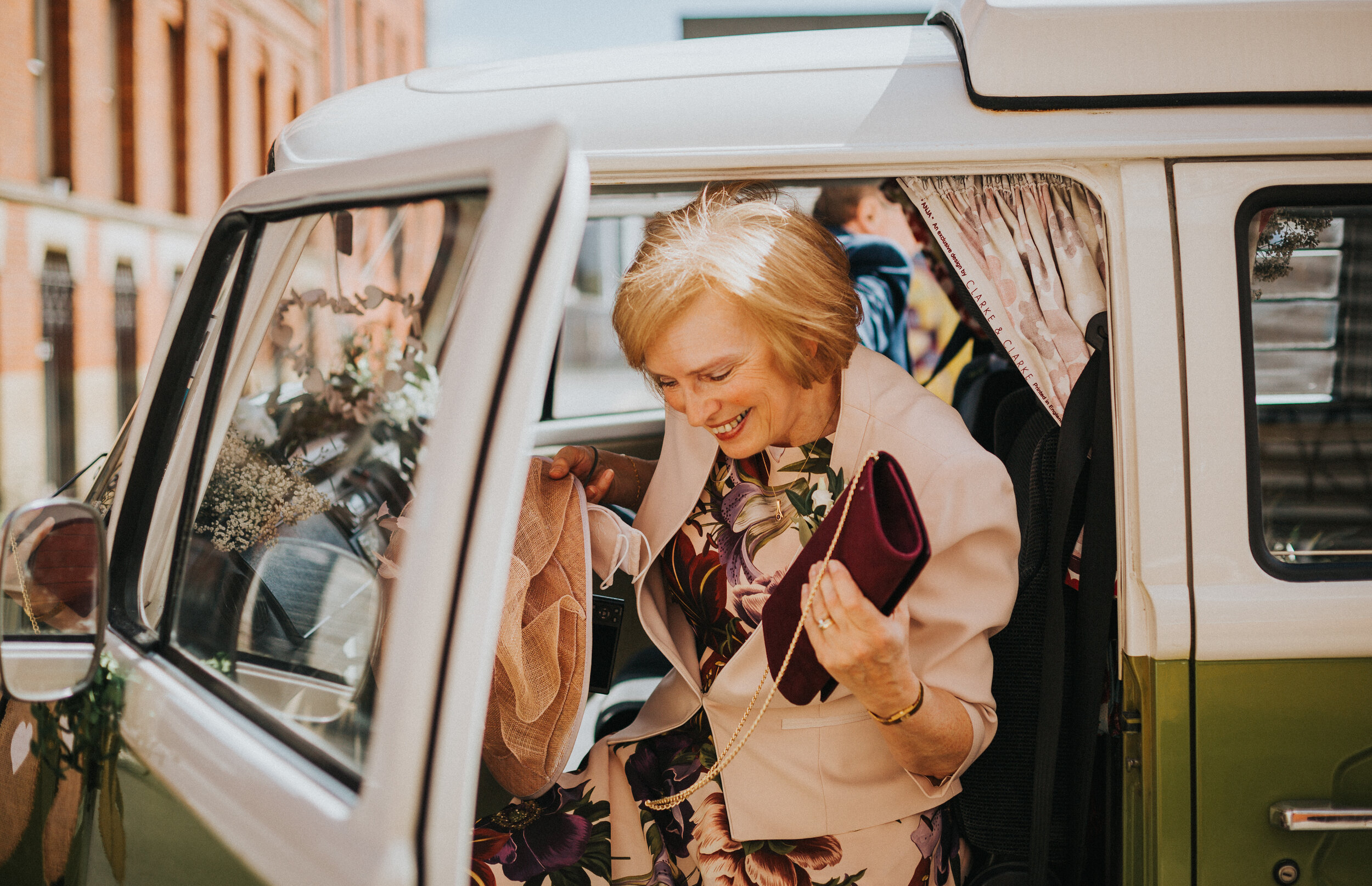 Mother of the bride exits green VW camper van looking stylish