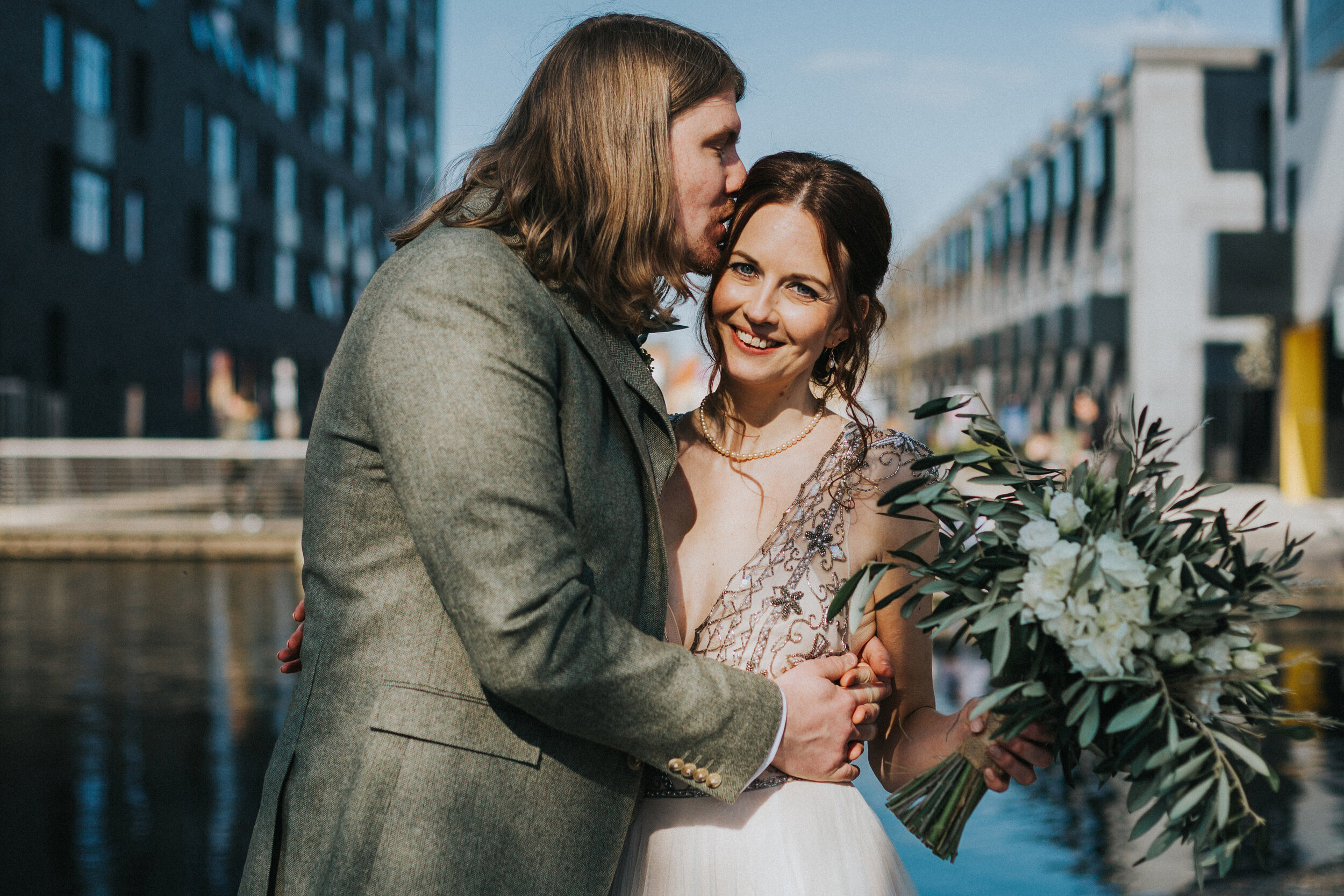 Groom give his Bride a kiss at their micro wedding in Manchester city centre. 