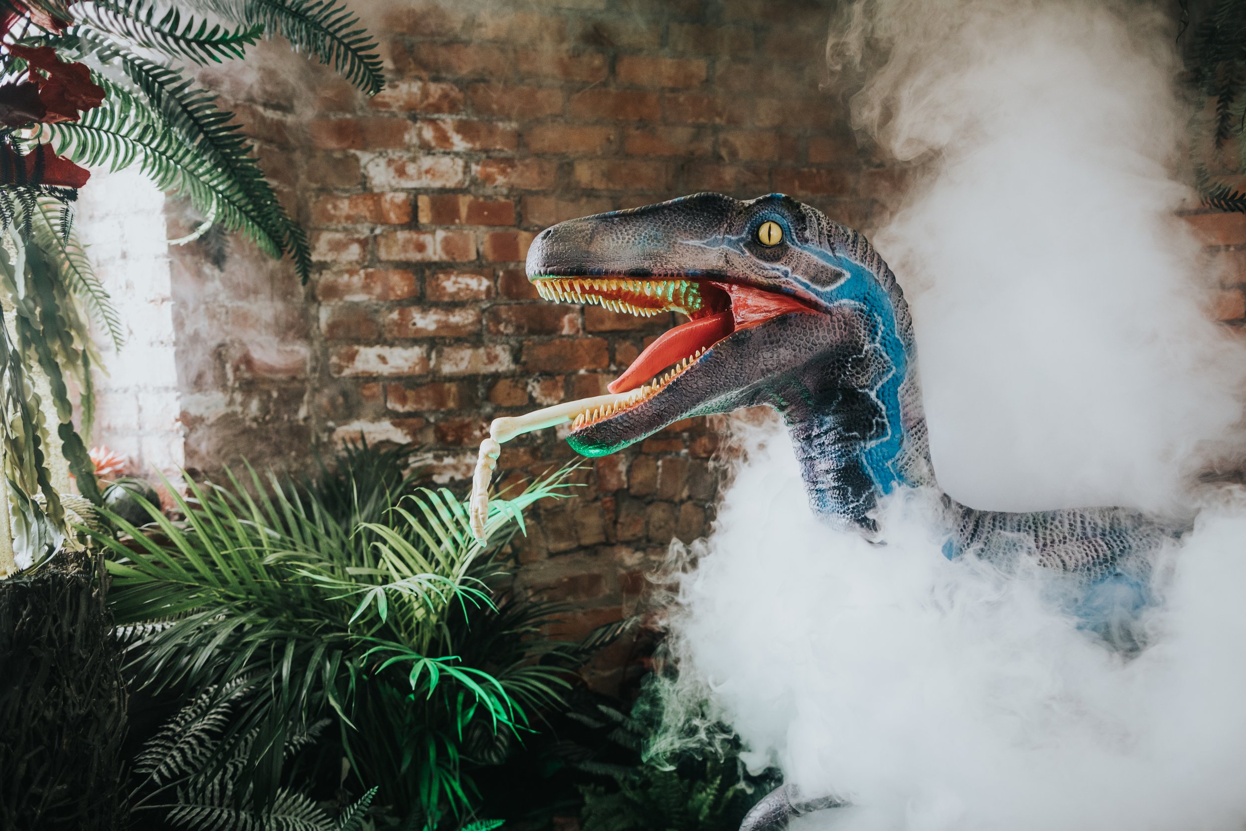 Blue, Velociraptor emerges out of the dry ice. 