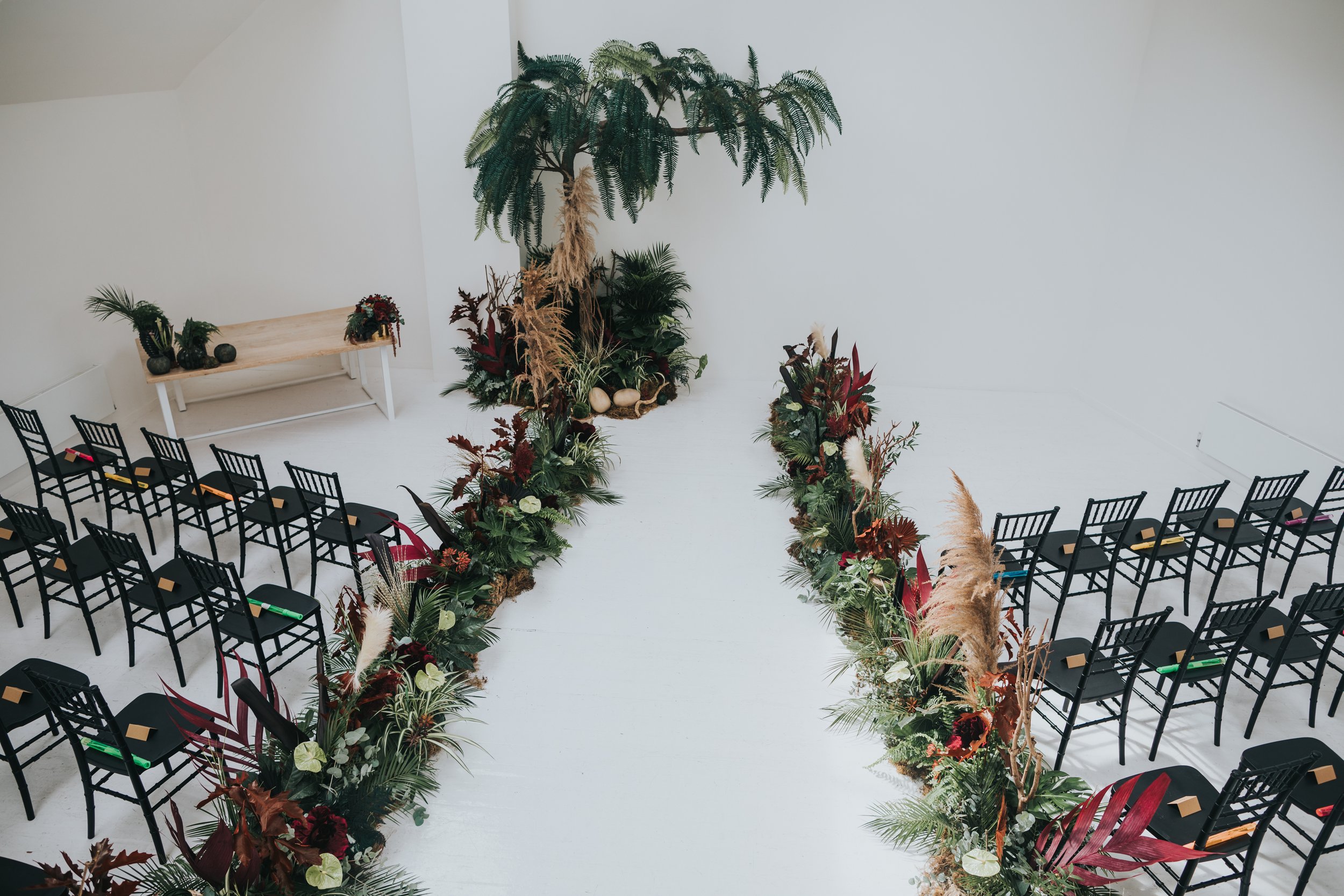 Five Four Studio top floor ready for the ceremony decorated with jungle foliage. 