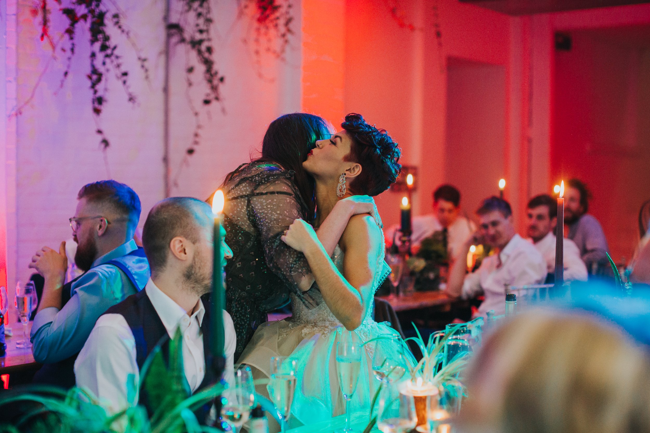 Bride hugs her bridesmaid. 