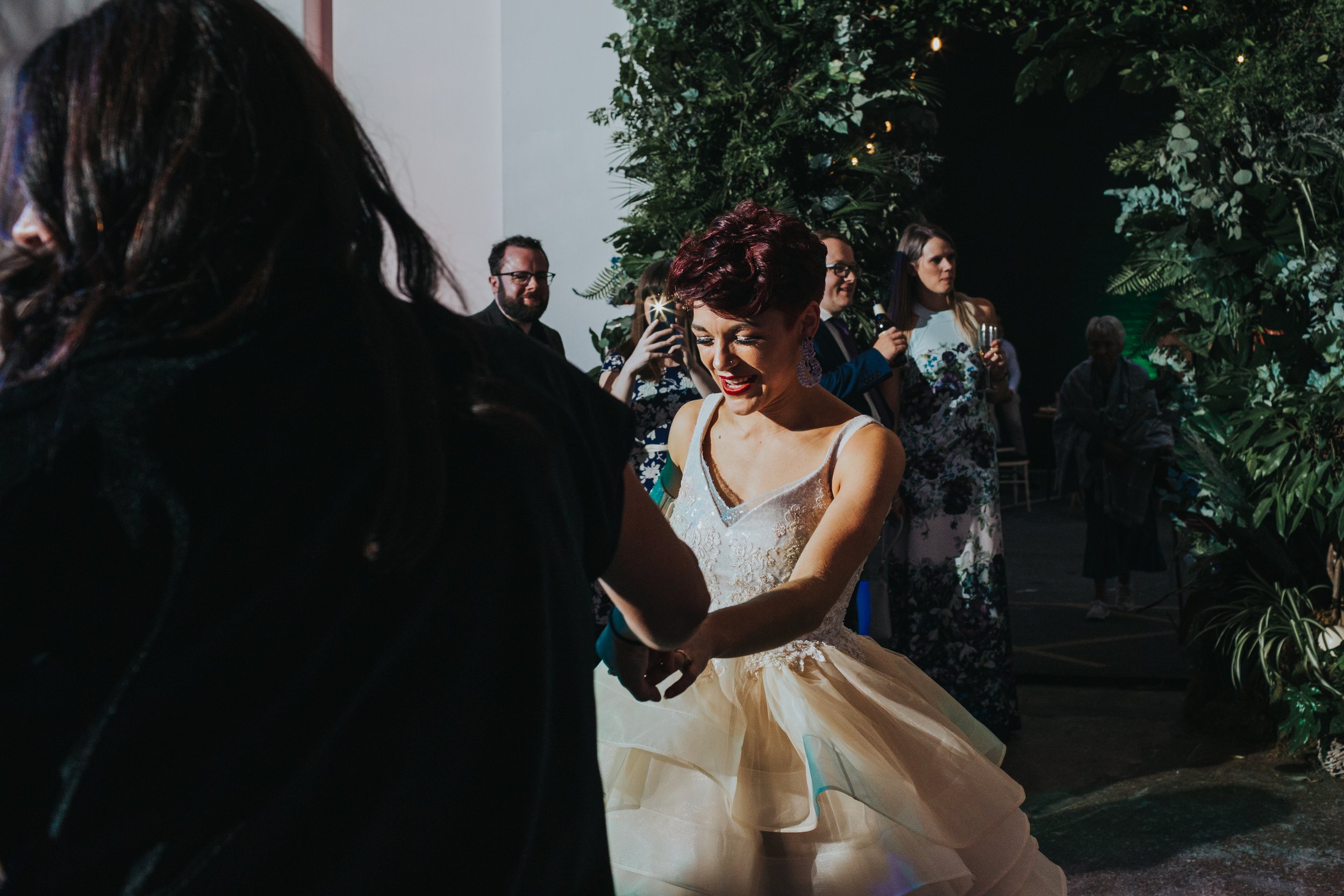 Bride dancing wearing her punk style wedding dress. 