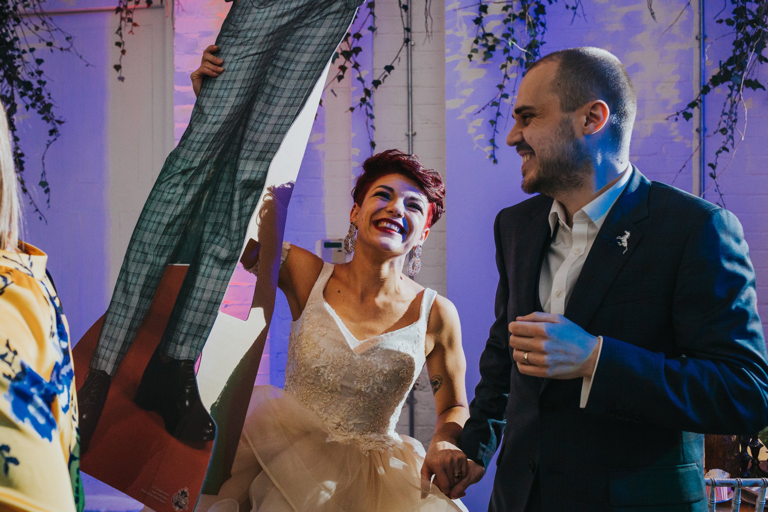 Bride and groom dancing with card board cut out guests. 