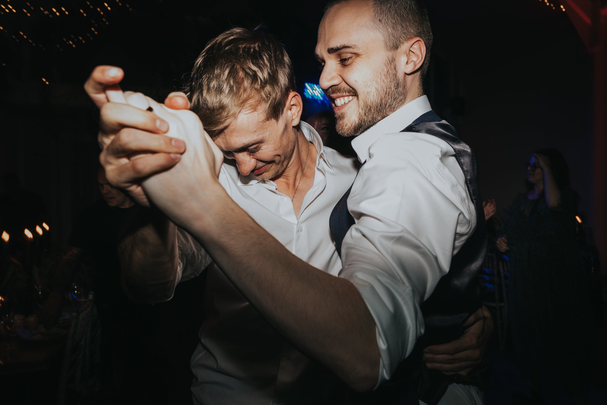 Best man and groom dancing together. 