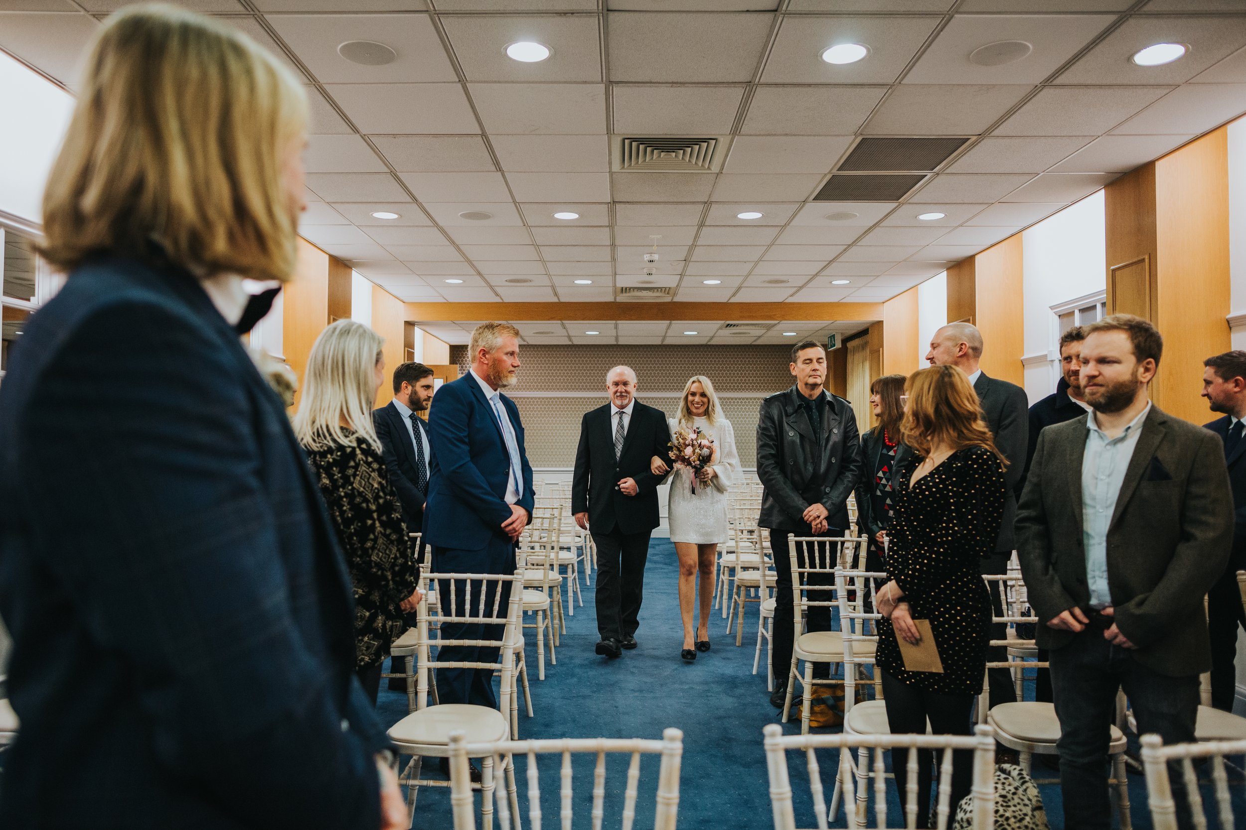 Bride is walked down the aisle by her father at Heron House. 