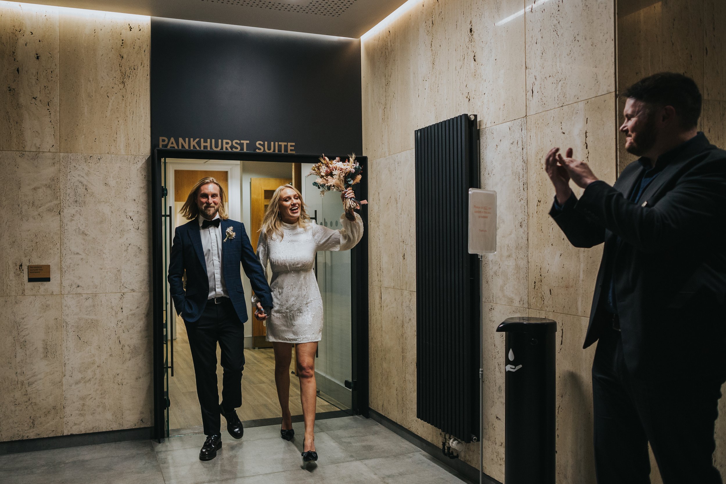 Bride and Groom exit the Pankhurst suite at Heron House Manchester as husband and wife. 