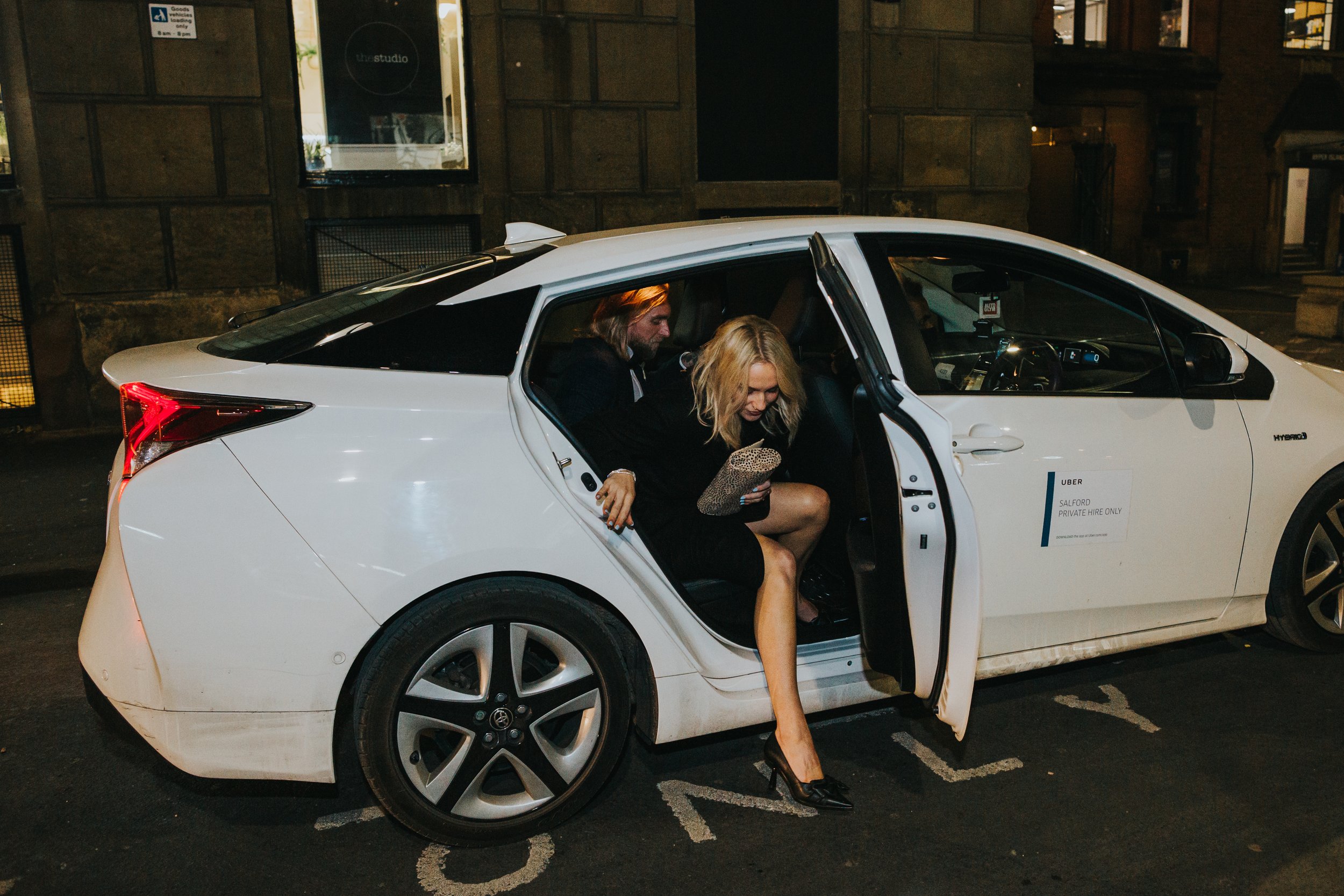 Bride and groom exit their Uber to go to their wedding reception at Flock